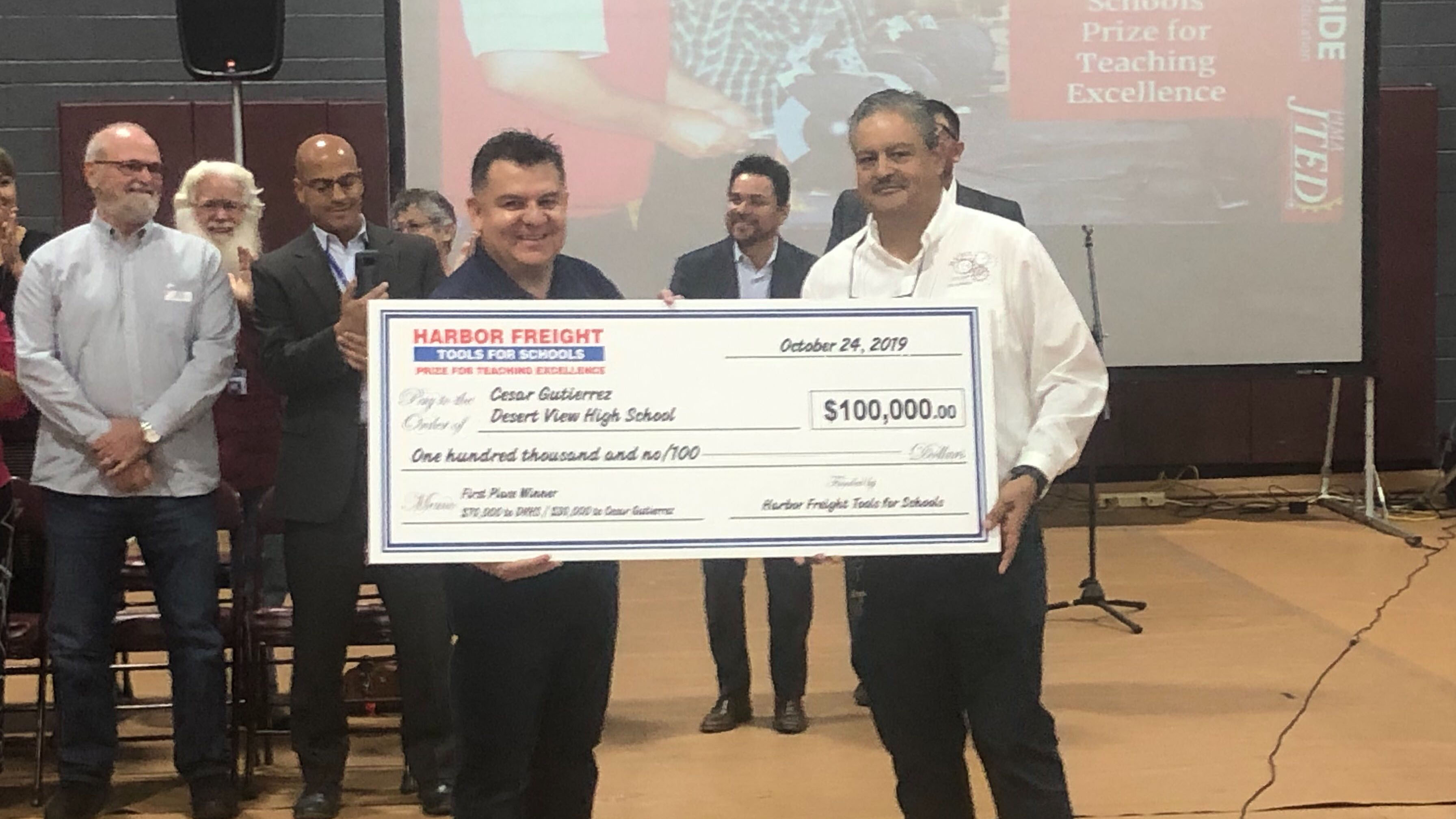 Cesar Gutierrez, right, receives the Harbor Freight Tools For Schools award for teacher excellence.  