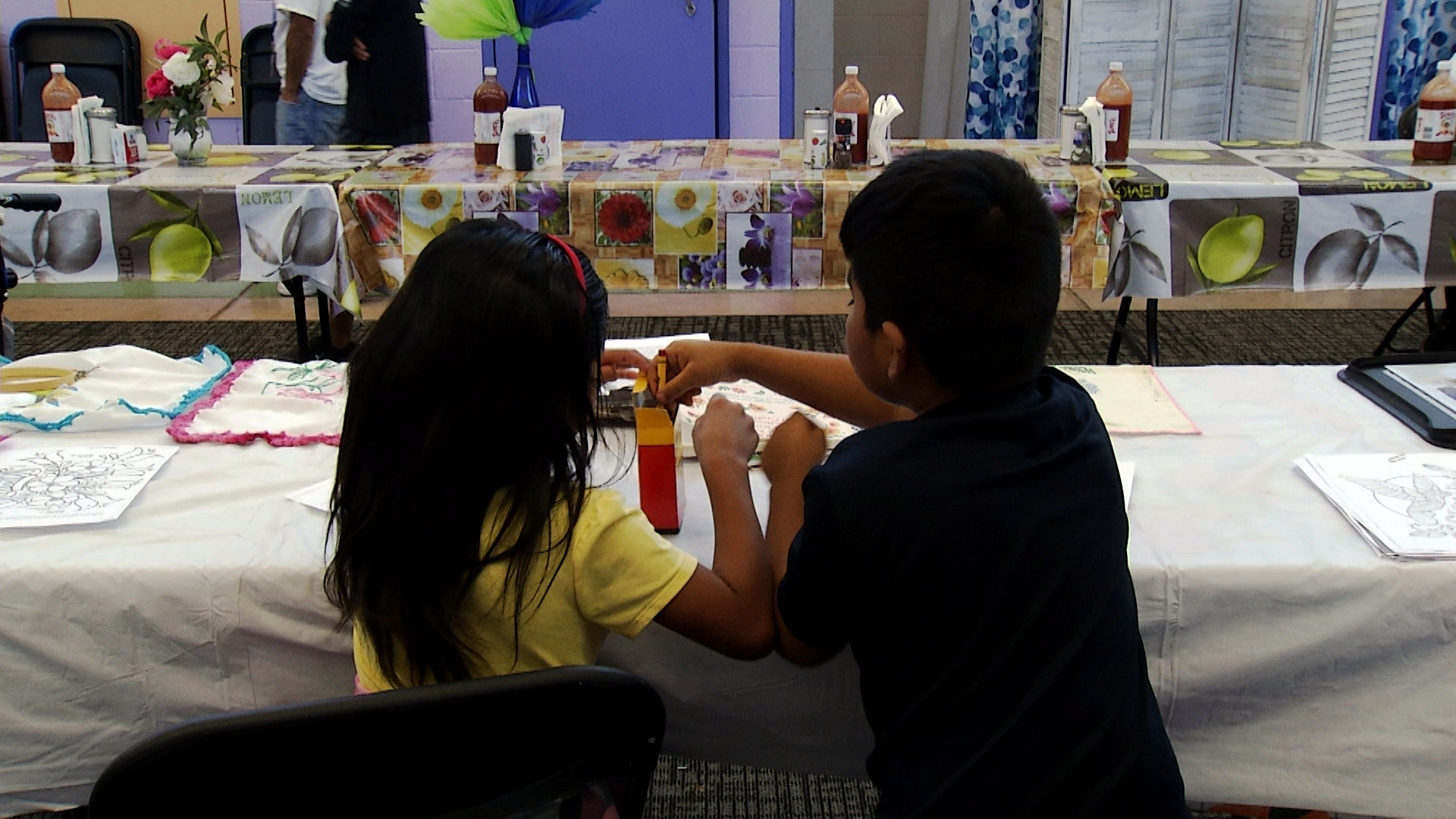 Two children color at Casa Alitas' shelter for migrants and asylum-seeking families on Sept. 30, 2019.