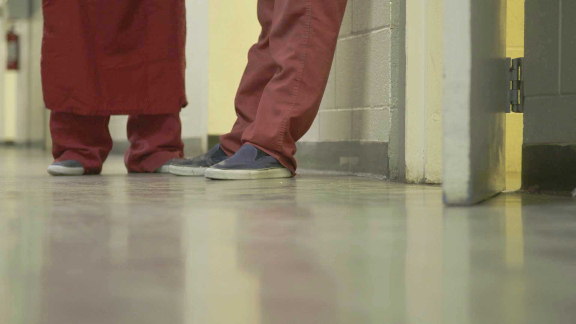 Two inmates stand in a hallway at the Pima County Jail.