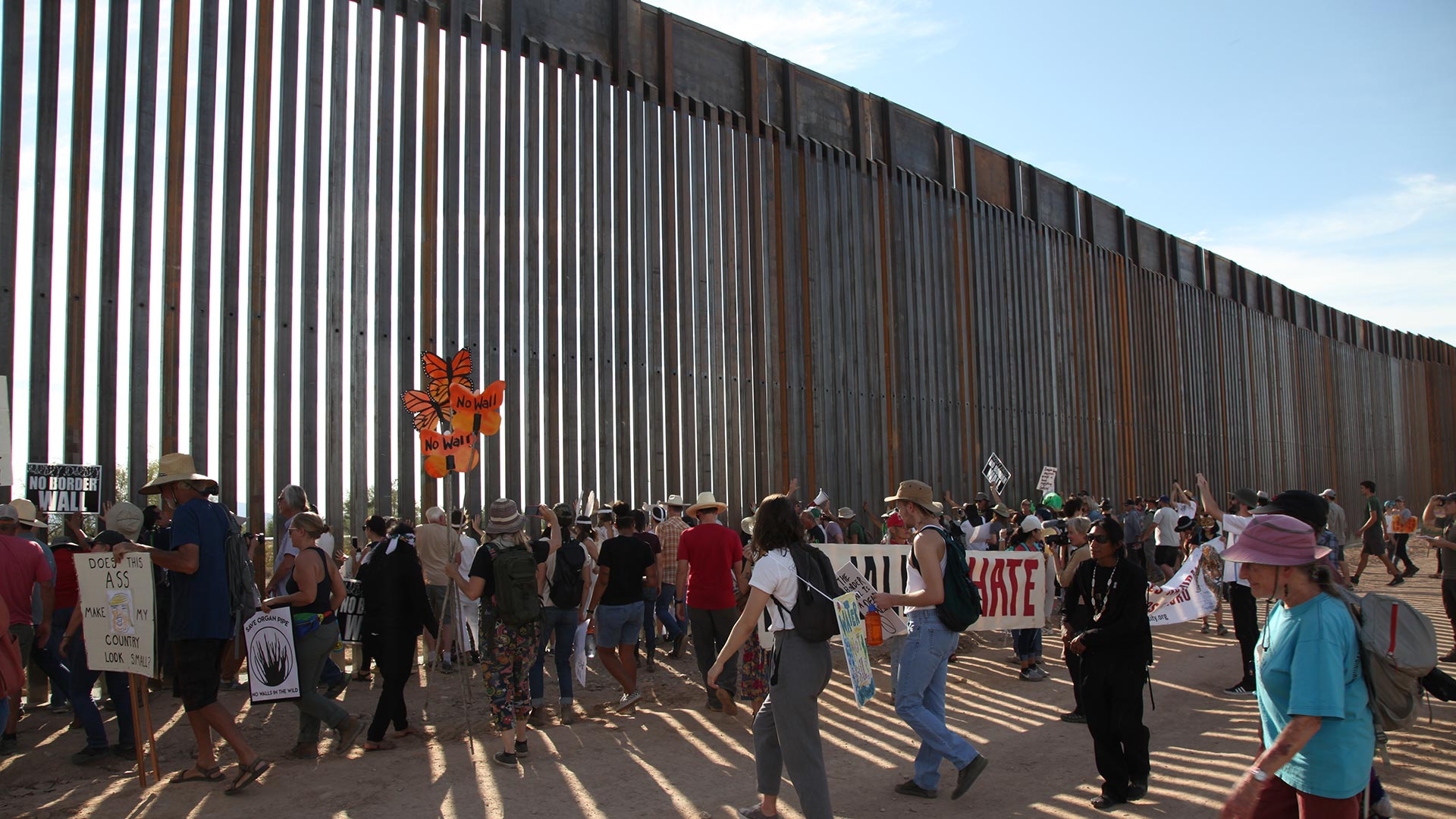 The crowd pounding on the U.S. - Mexico border wall chanting "tear down this wall" during a protest in Organ Pipe Cactus National Monument, Saturday, November 9, 2019.