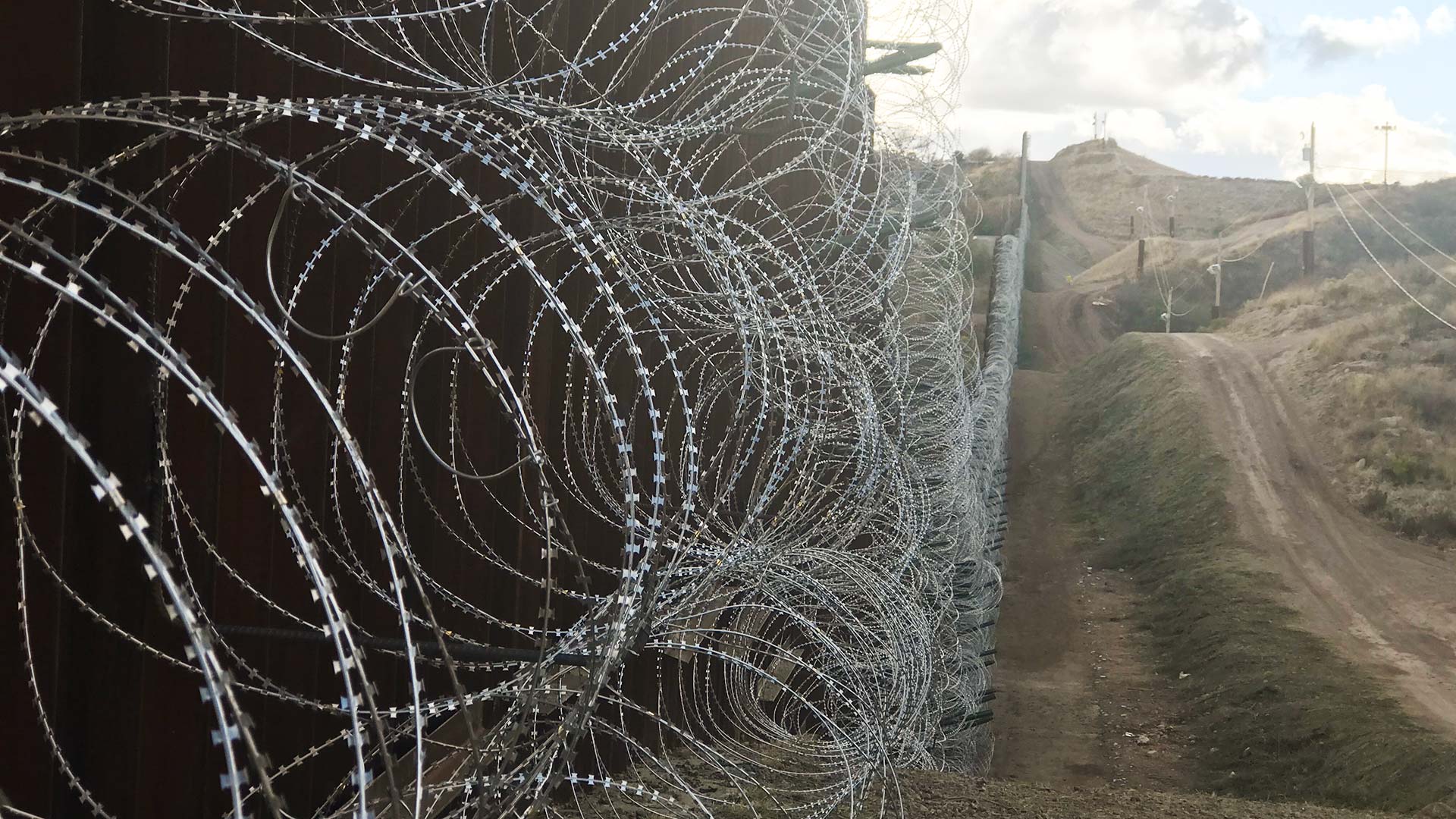 Rows of razor wire cover the U.S. side of a section of the wall near Nogales, Arizona.