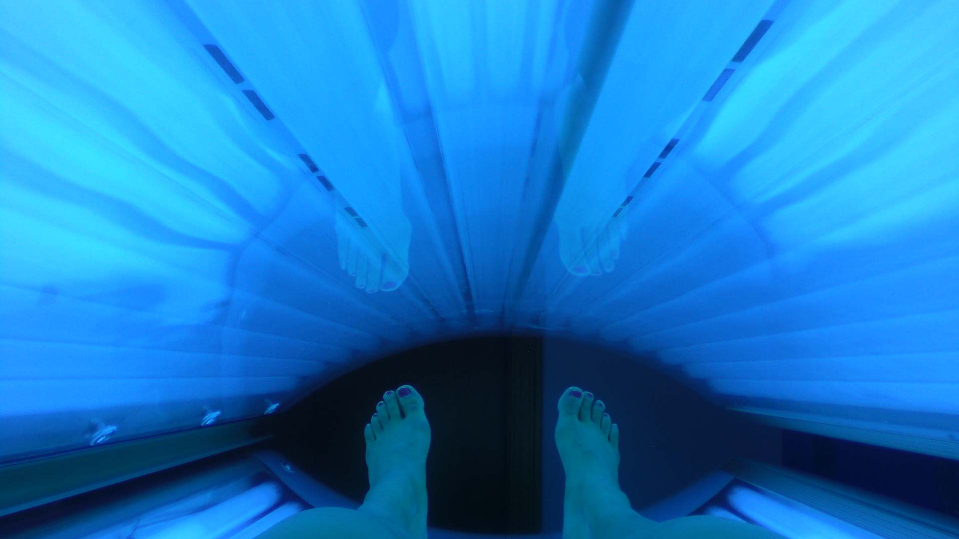 A person uses a tanning bed.