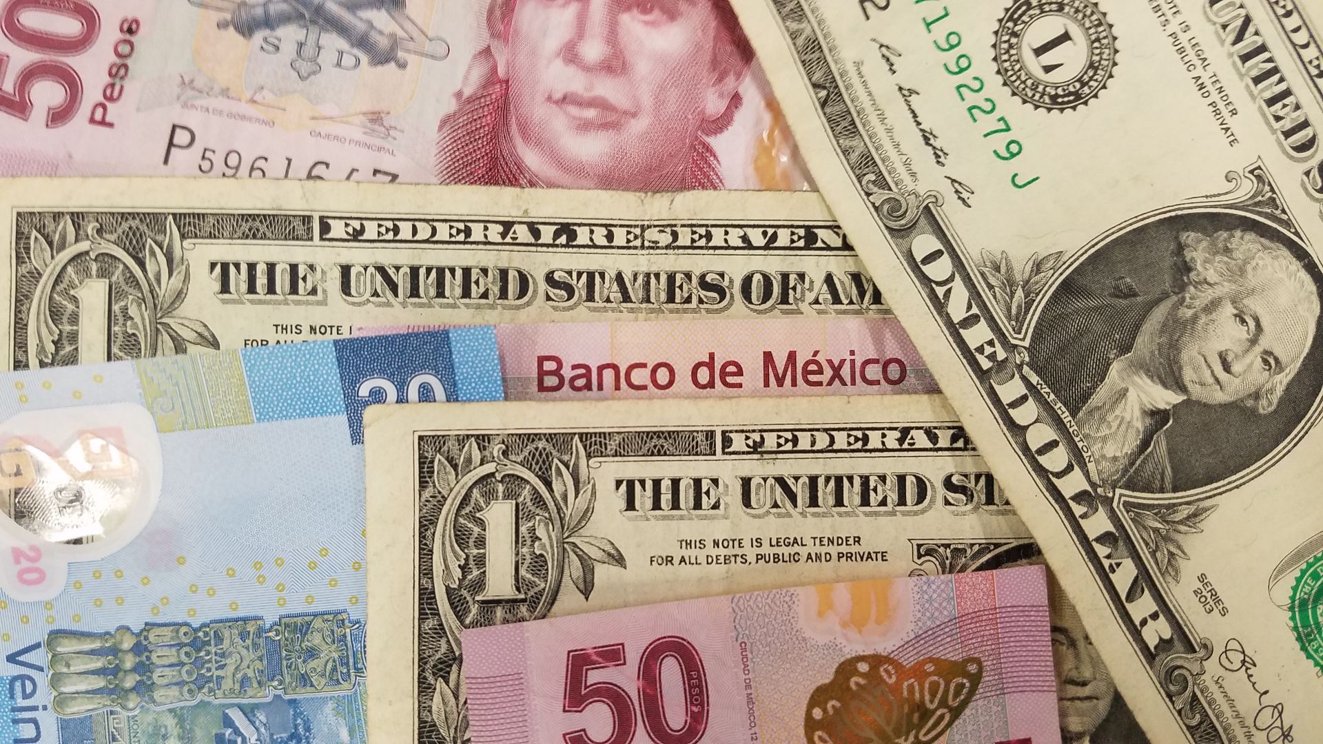 File image of Mexican pesos and American dollars.