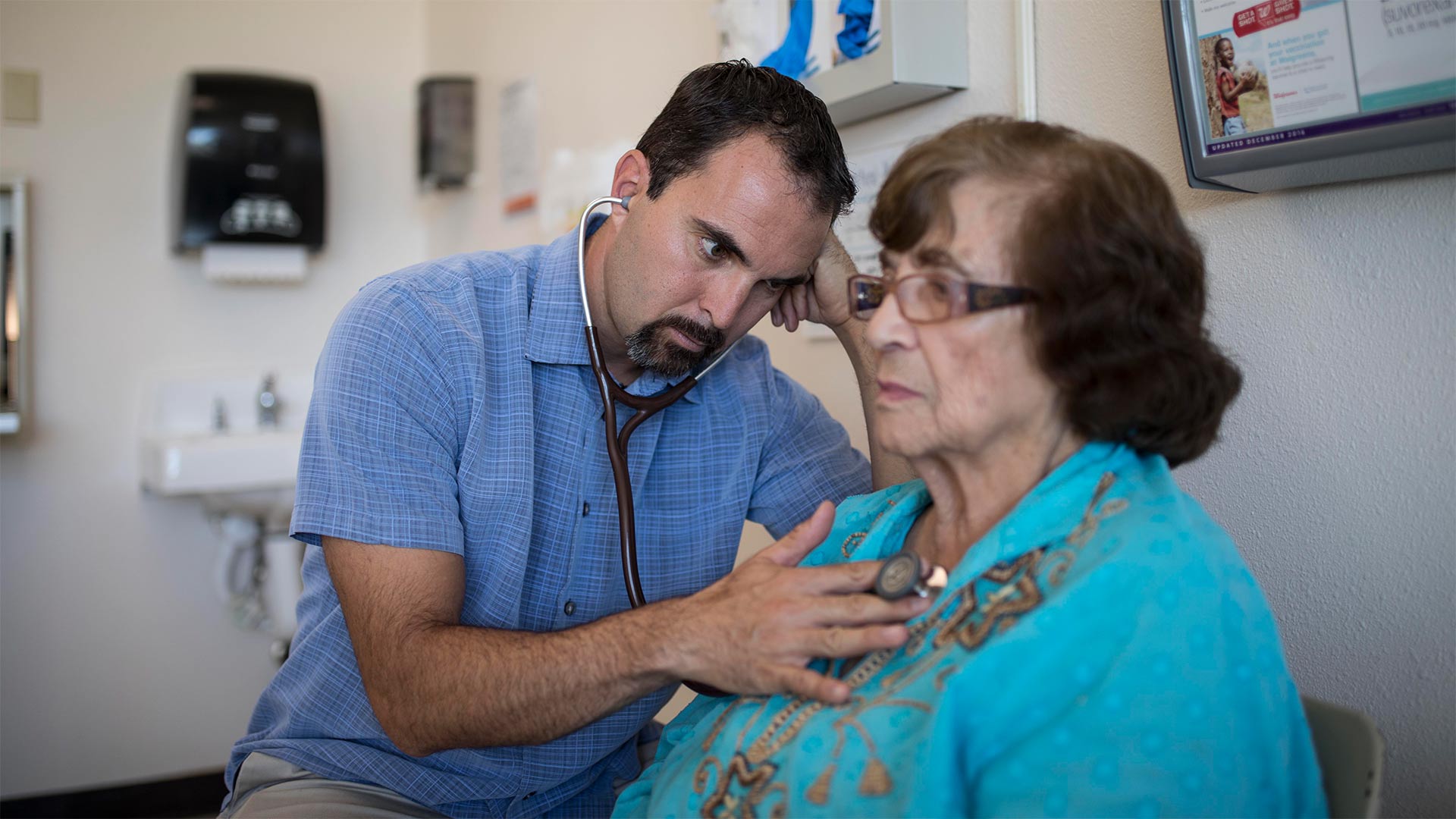 El Centro Family Health Medical Director Matt Probst listens to a patient's heart.

