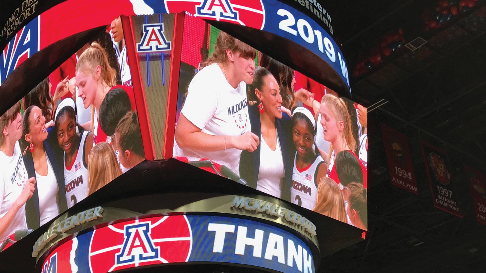 UA Women's basketball coach Adia Barnes celebrates with her team after winning the Women's National Invitation Tournament championship at McKale Center in Tucson, April 6, 2019.