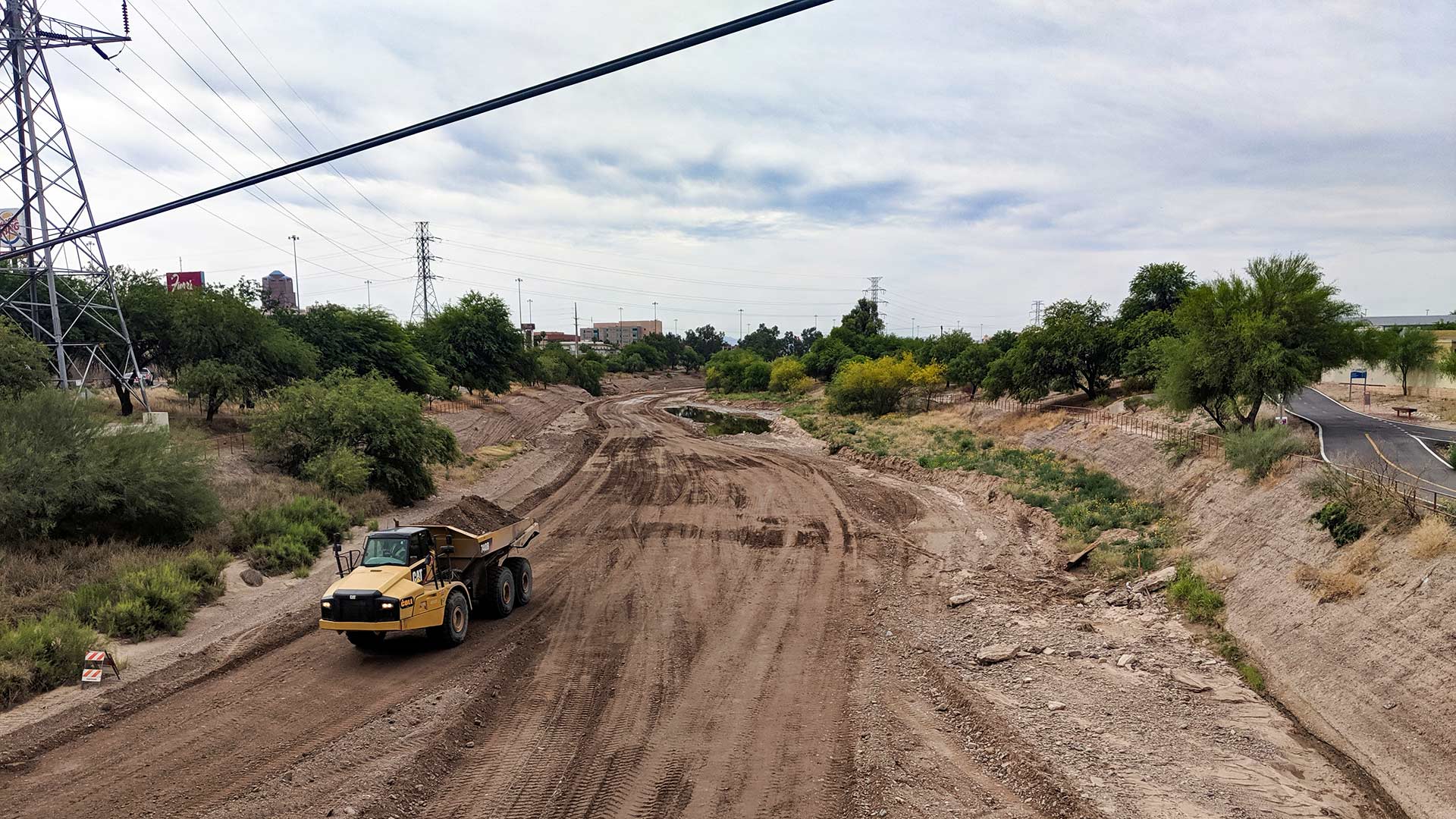 A truck hauls a load of dirt in the riverbed of the Santa Cruz where it's crossed by St. Mary's, May 16.