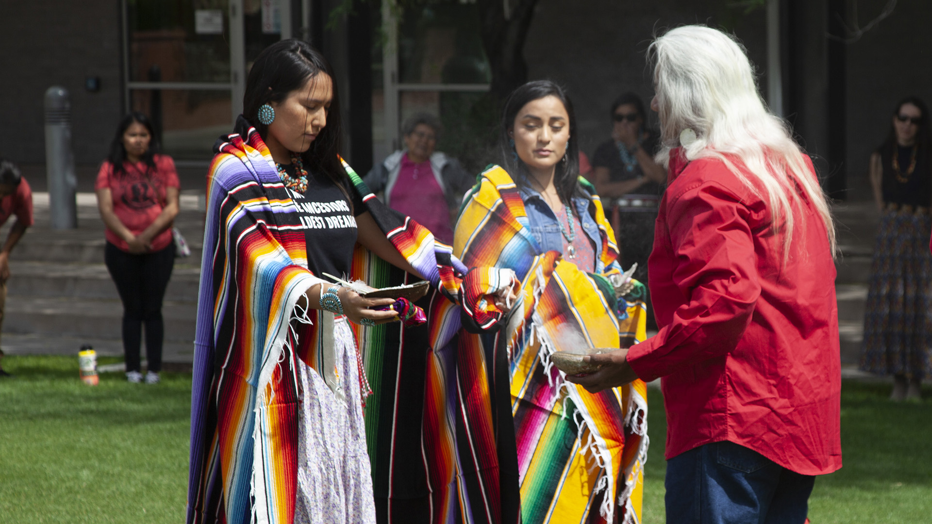 Two medical students from the graduating class of 2019 participate in a blessing ceremony May 10, 2019, that honored the work they've done in their program.