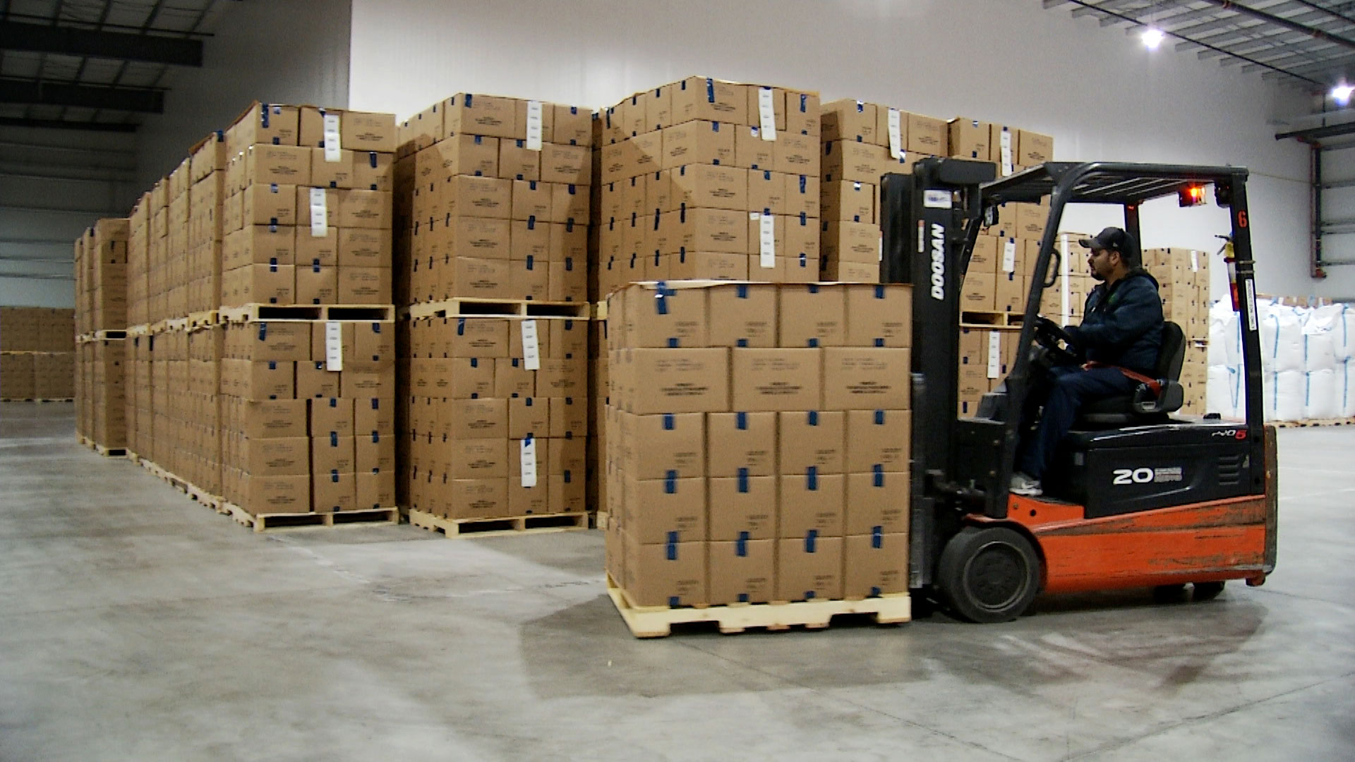 A forklift driver hauls a pallet with boxes of pecan products inside the cold storage facility at the Green Valley Pecan Company in Sahuarita on June 3, 2019.