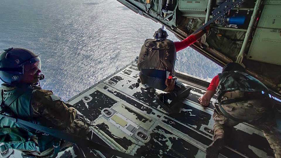 Pararescue jumpers from the 563rd Rescue Group at Davis-Monthan Air Force Base prepare to parachute to a fishing vessel in the Pacific Ocean, July 2019