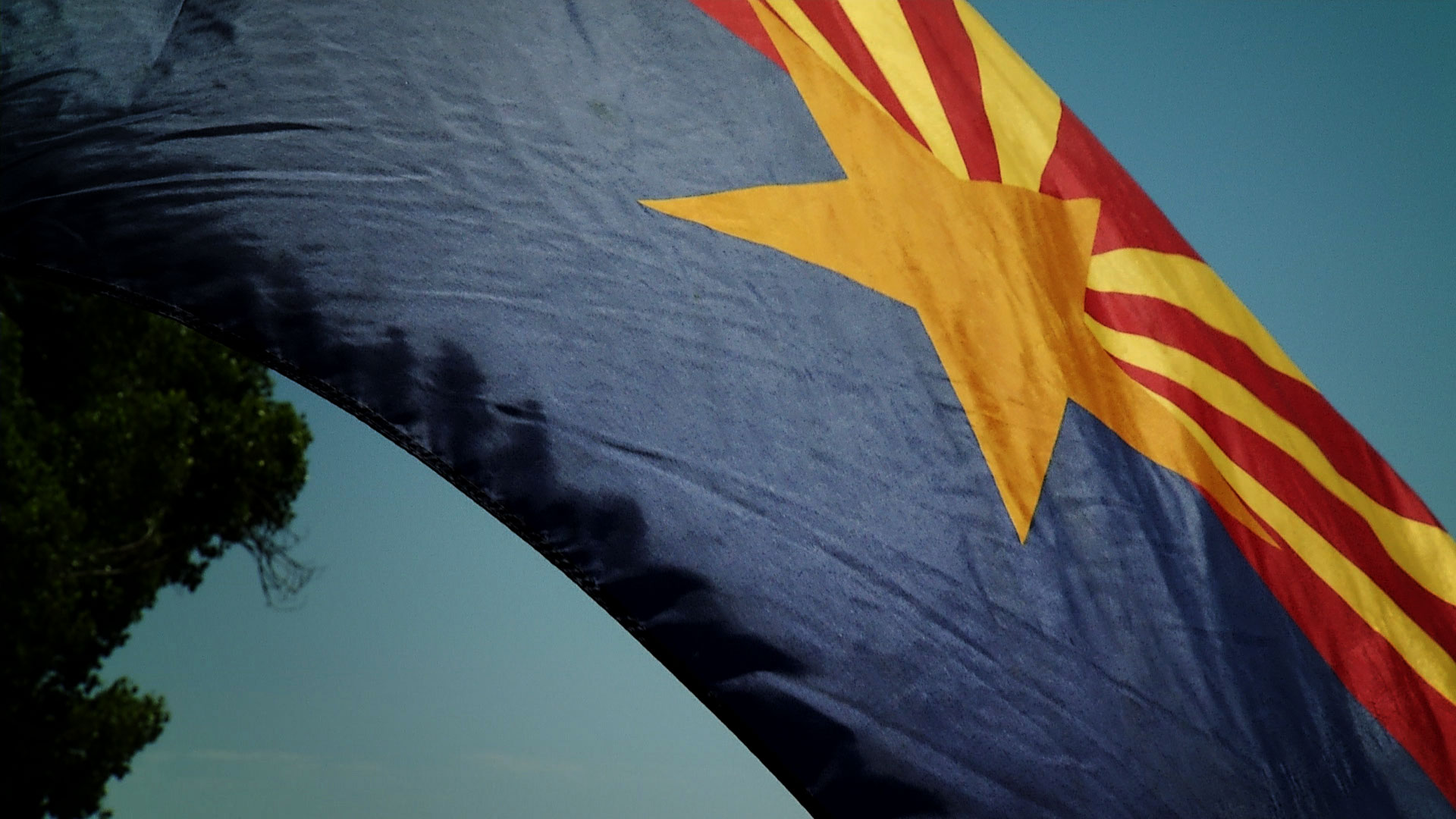 The Arizona flag waves in the wind on a flagpole in Willcox. 