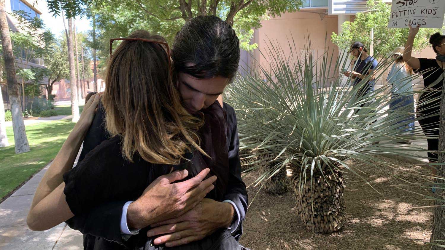 Scott Warren hugs a supporter after the government announces it will seek to try him again on two felony counts on July 2, 2019.