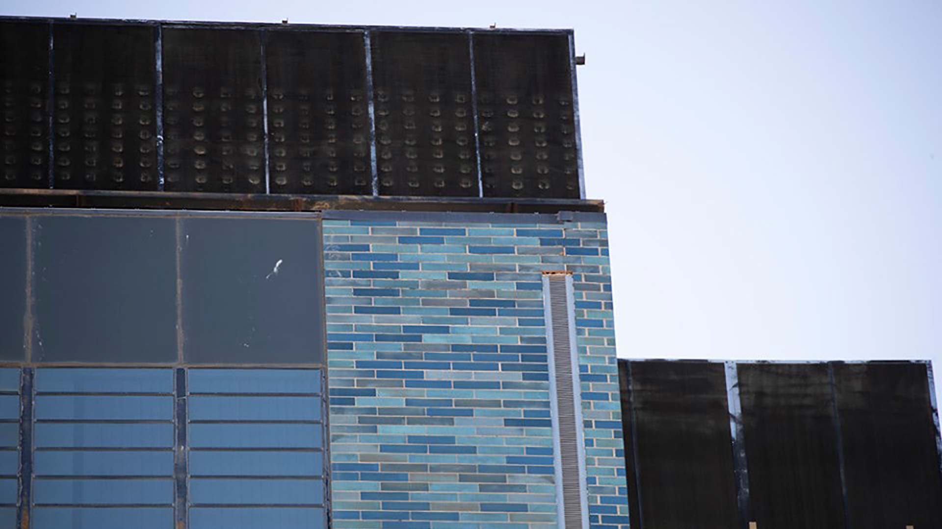 This image distributed by Pima County via social media on Aug. 14, 2019 shows a part of the county's Legal Services Building, where distinctive blue-green bricks have dislodged. Efforts are underway to find and repair loose bricks on the the building, built in 1967.