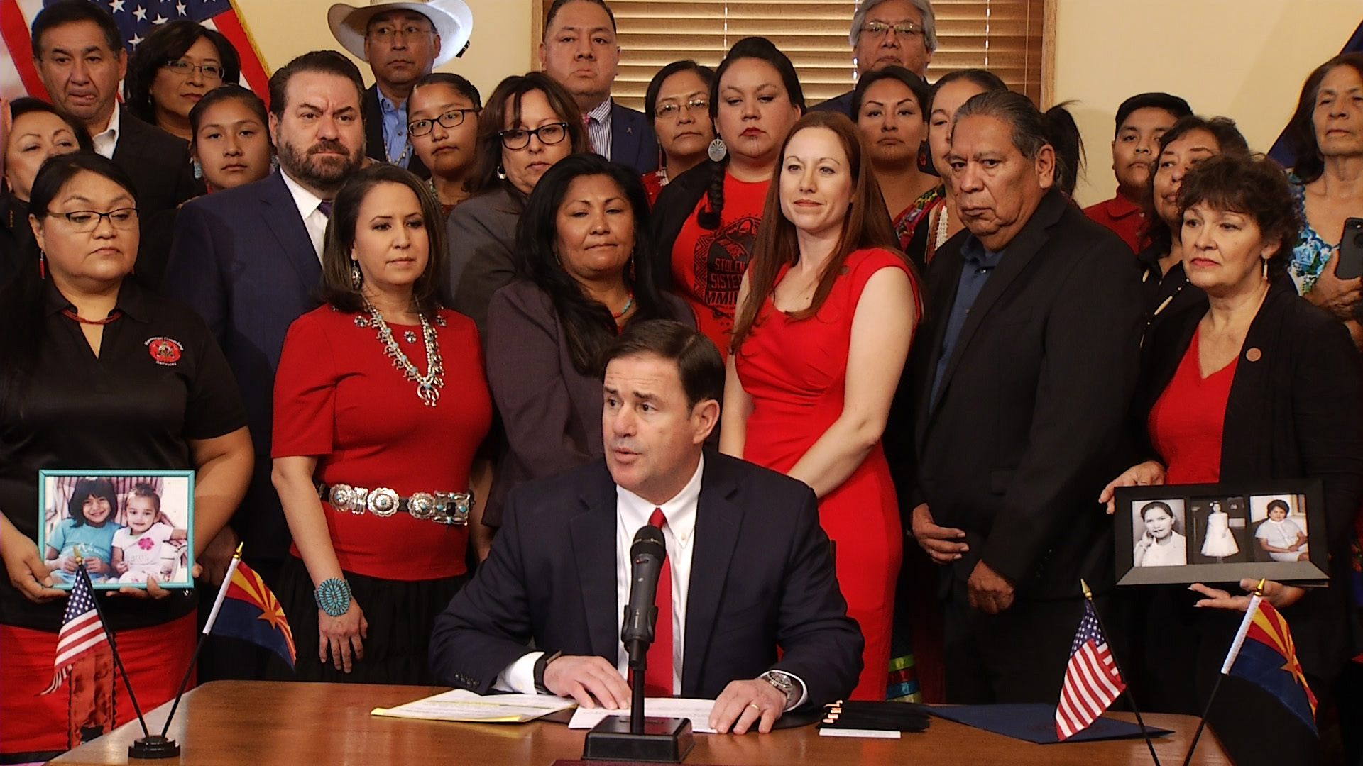 Gov. Doug Ducey holds up HB 2570, a law that will require the state to collect data on missing and murdered Indigenous women and girls, at the ceremonial signing Aug. 13, 2019. 