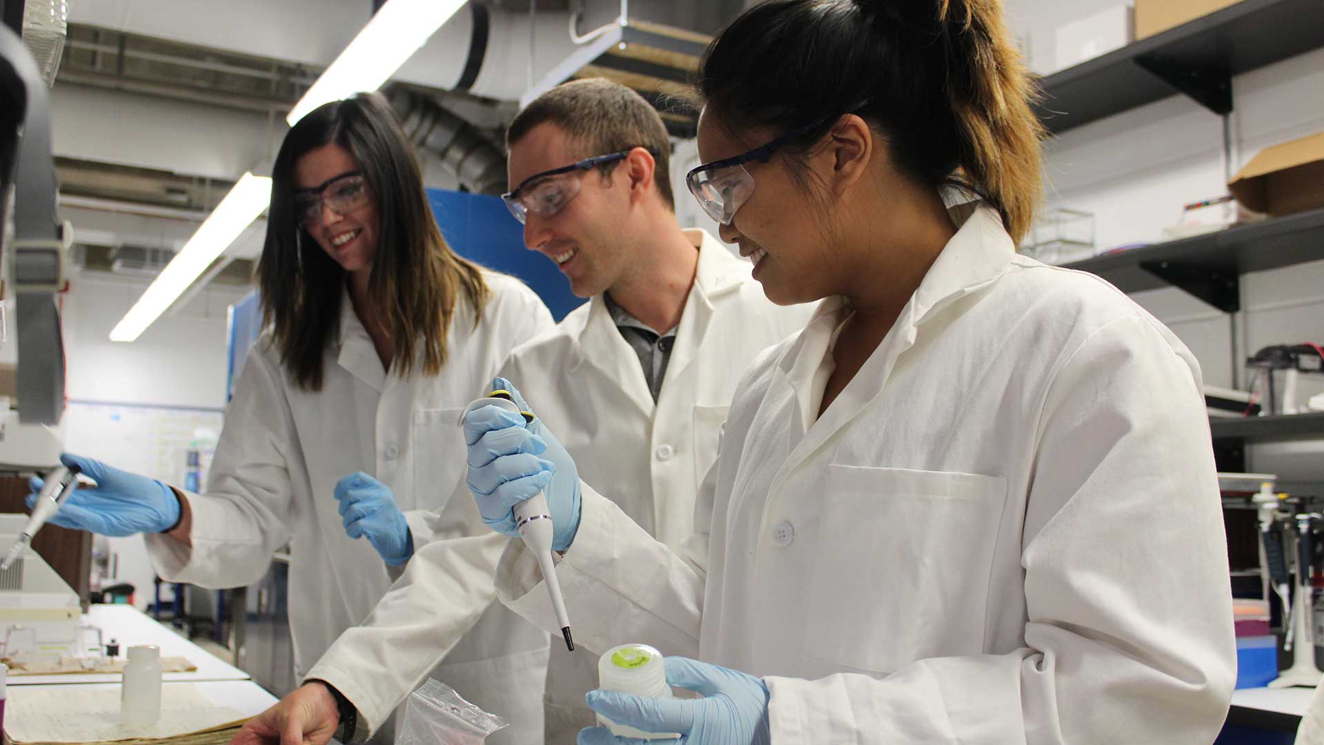 UA professor Michael Marty, center, with two students in his biochemistry lab. 