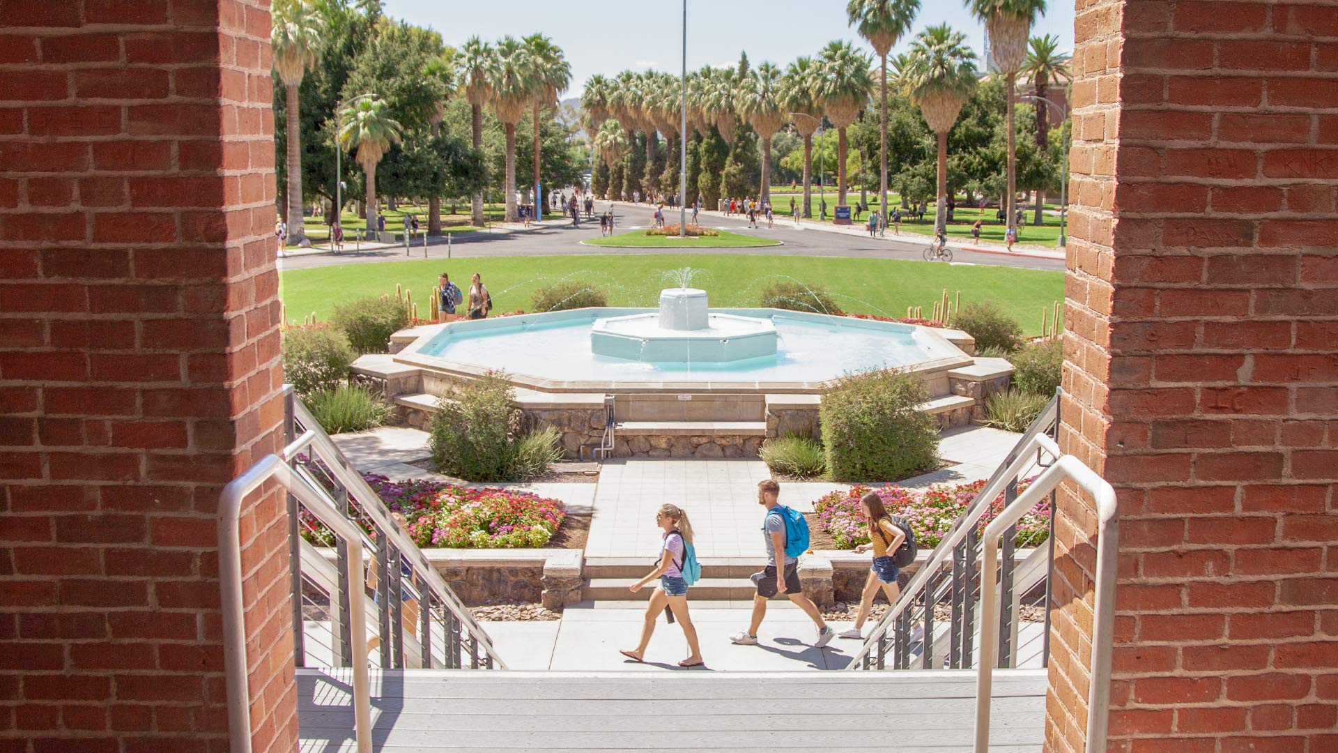 Students walk near the fountain at Old Main on the University of Arizona campus. From August 2019.