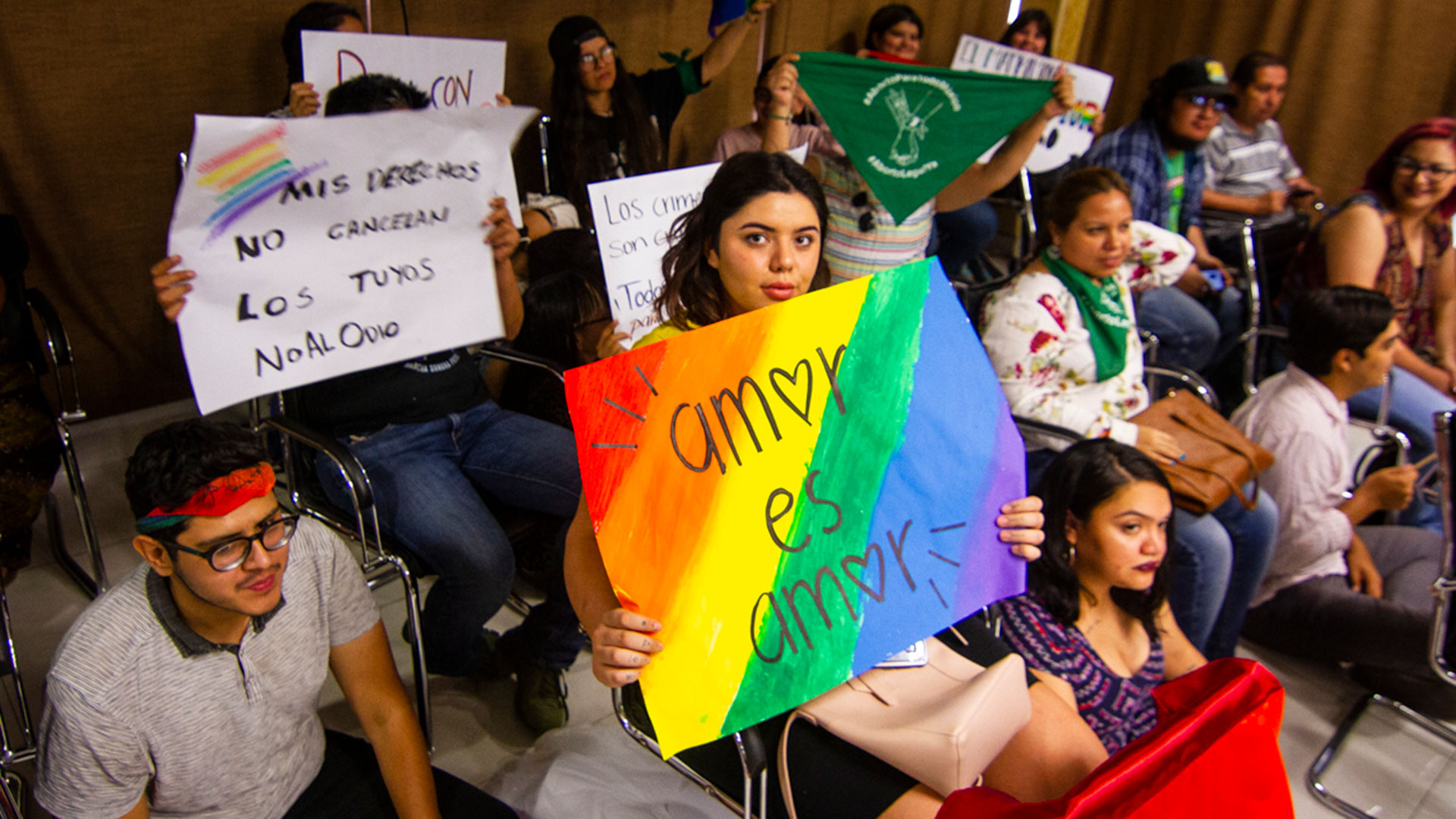 Dozens of supporters at a hearing presenting a marriage equality reform measure in Hermosillo, Sonora. The sign in the center reads, "Love is love."