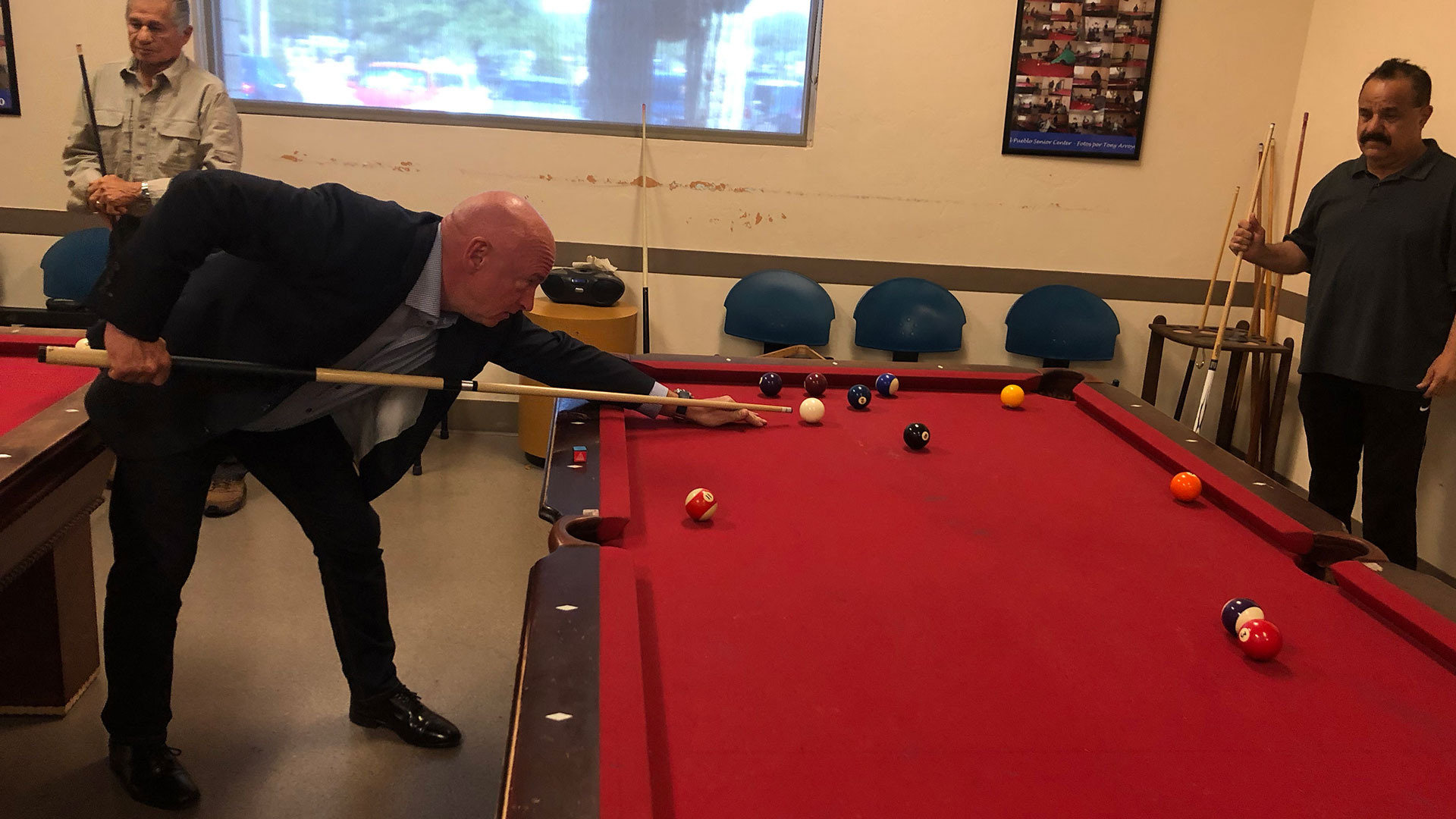 Democratic candidate for U.S. Senate Mark Kelly plays pool with senior citizens at the El Pueblo Center in Tucson, Sept. 17, 2019