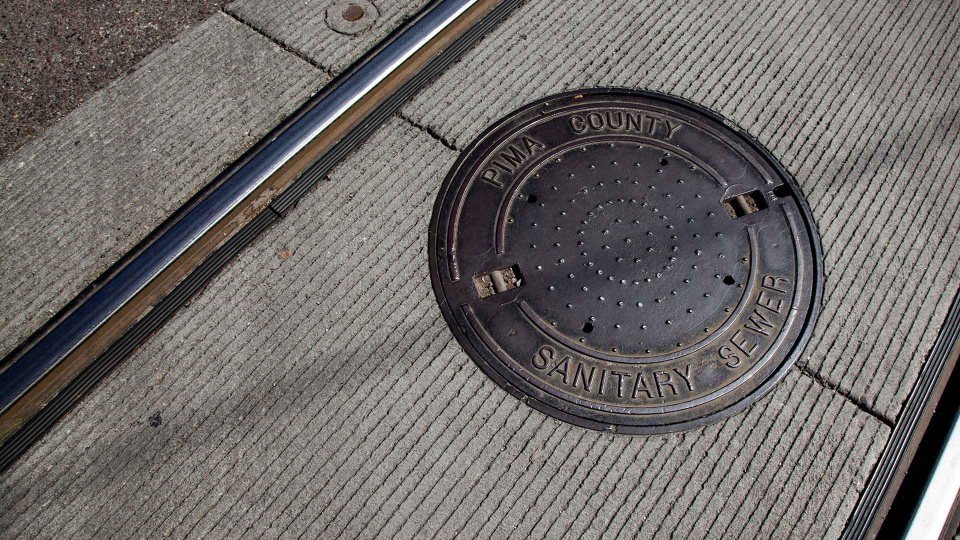 A Pima County sewer cover, along Tucson's streetcar line.