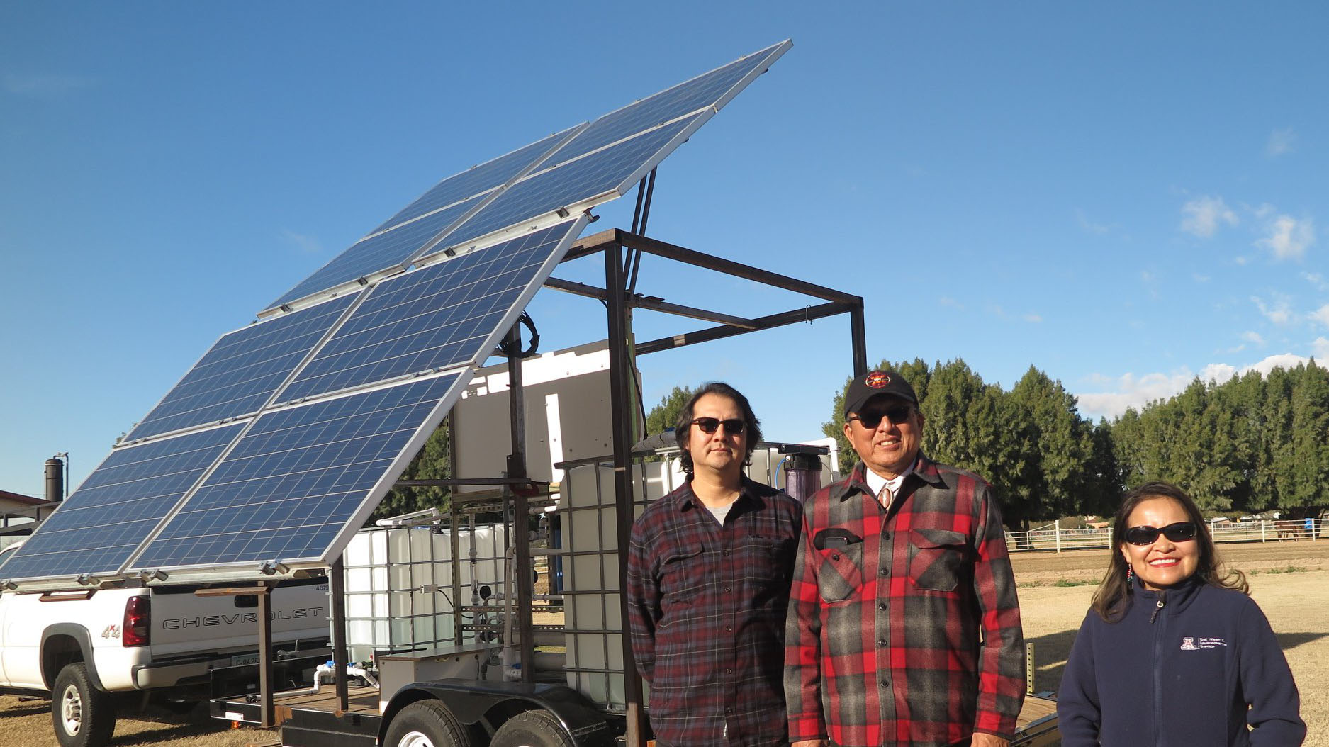 UA and National Science Foundation officials with a solar powered purification system on the Navajo Nation.