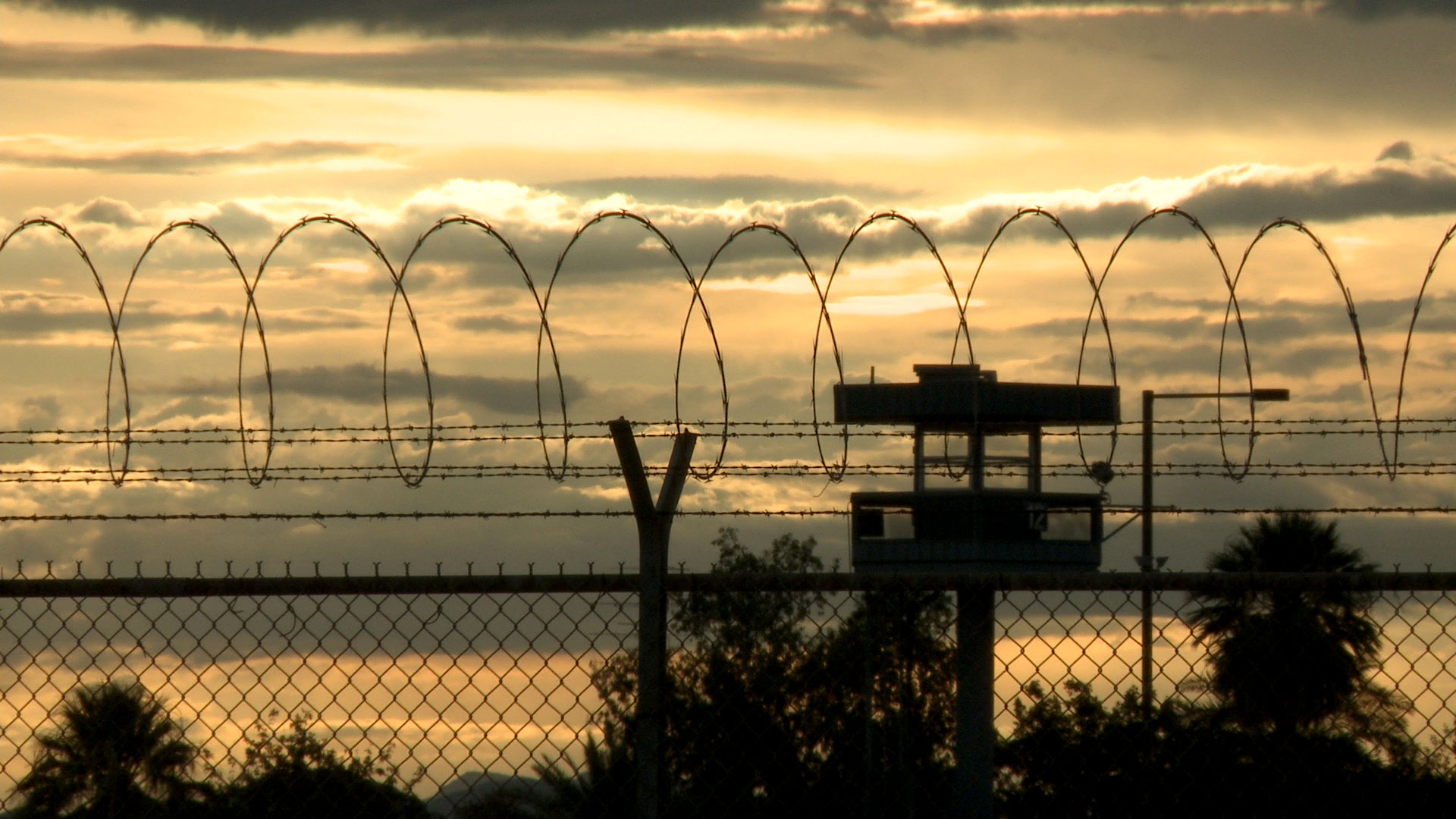 A watchtower seen in the distance at the Florence State Prison. 