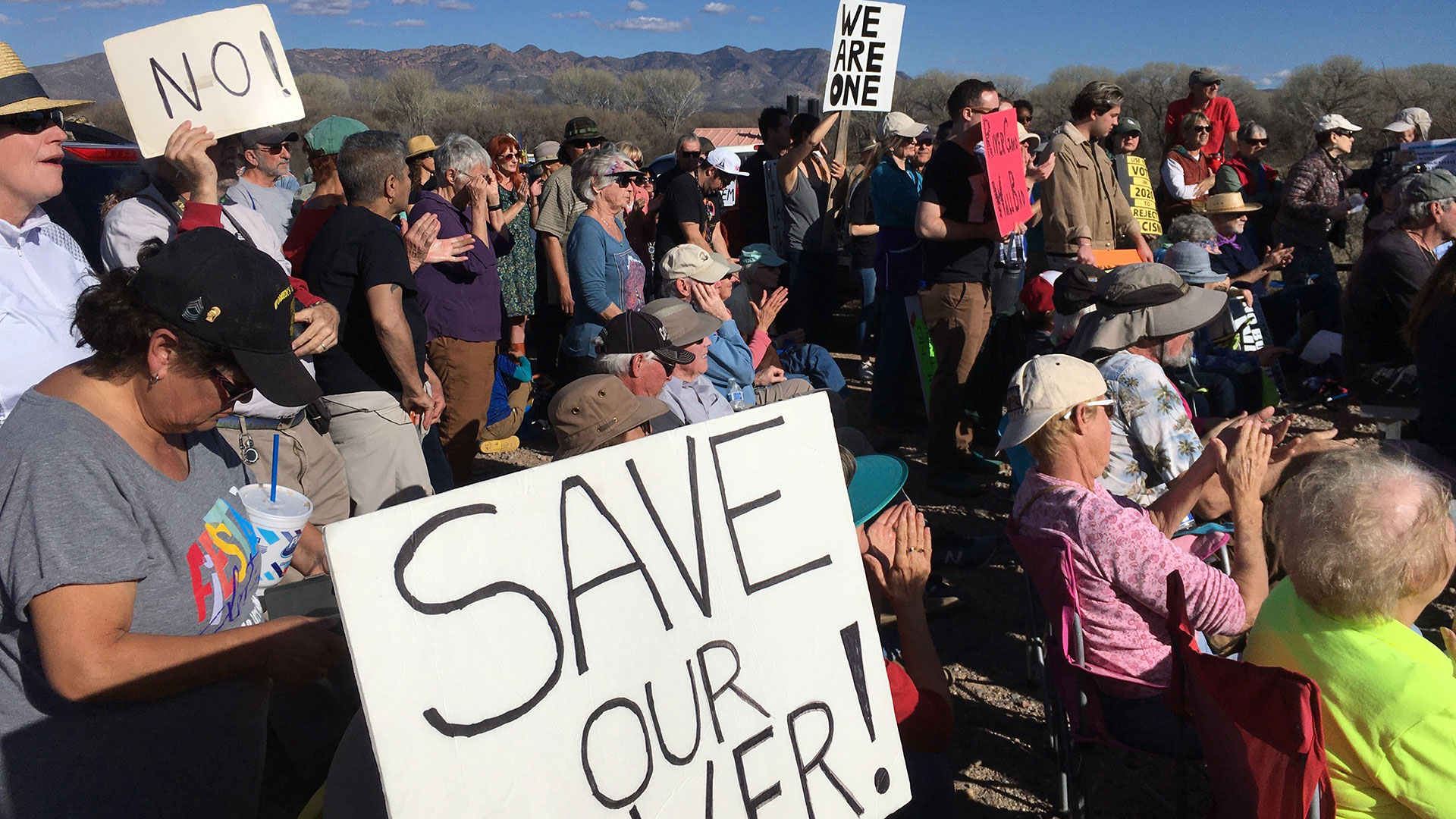 Demonstrators gather Sunday, Jan. 26 to protest the construction of border wall across the San Pedro River.