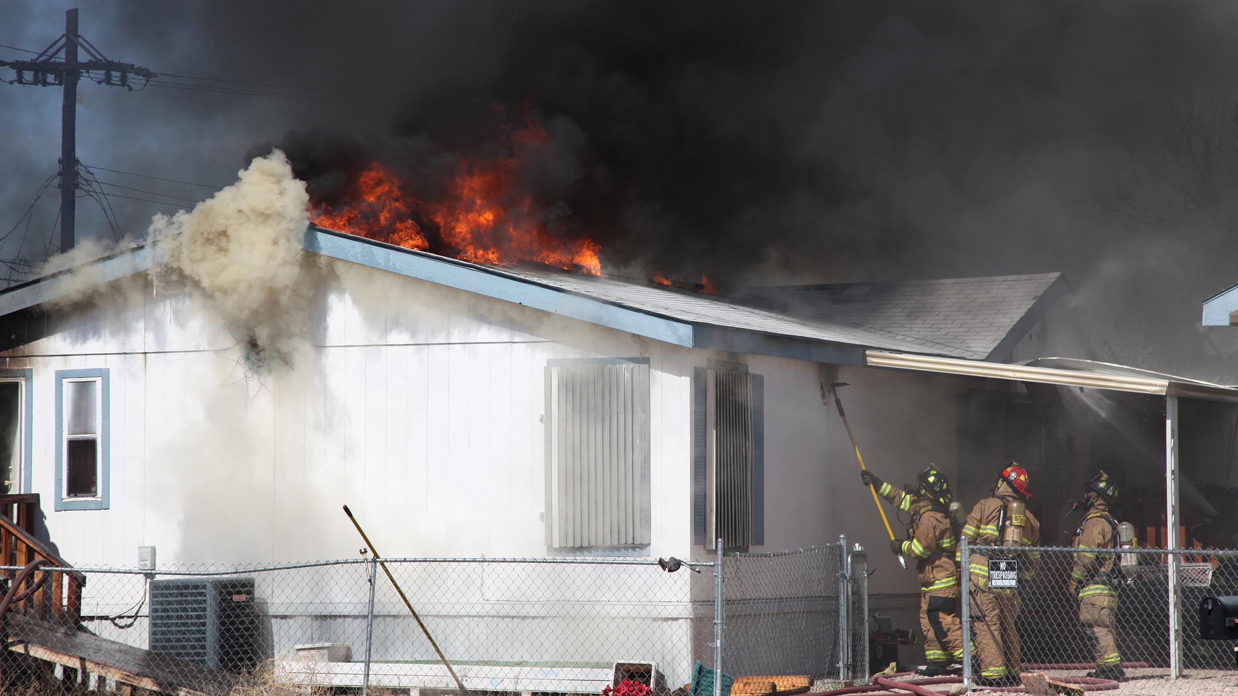 Firefighters in Tucson battle a house fire, 2016.