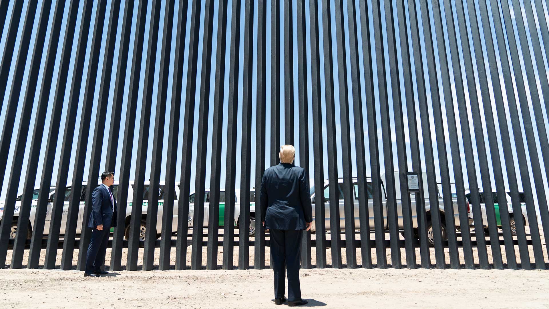 President Donald Trump stands at a section of border wall on the southern border near Yuma, June 23, 2020.