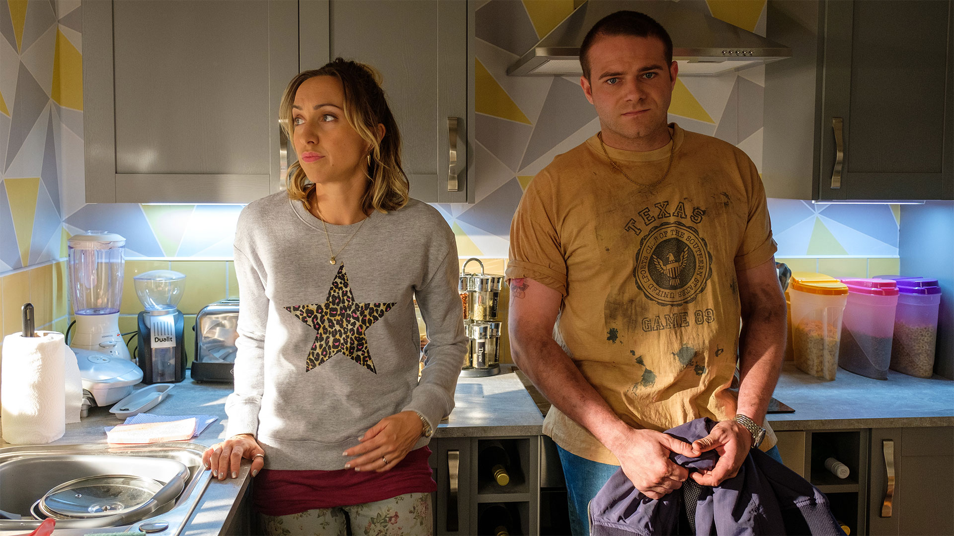 Kerry Howard as Kelly Roberts and Joe Layton as Neil Roberts.