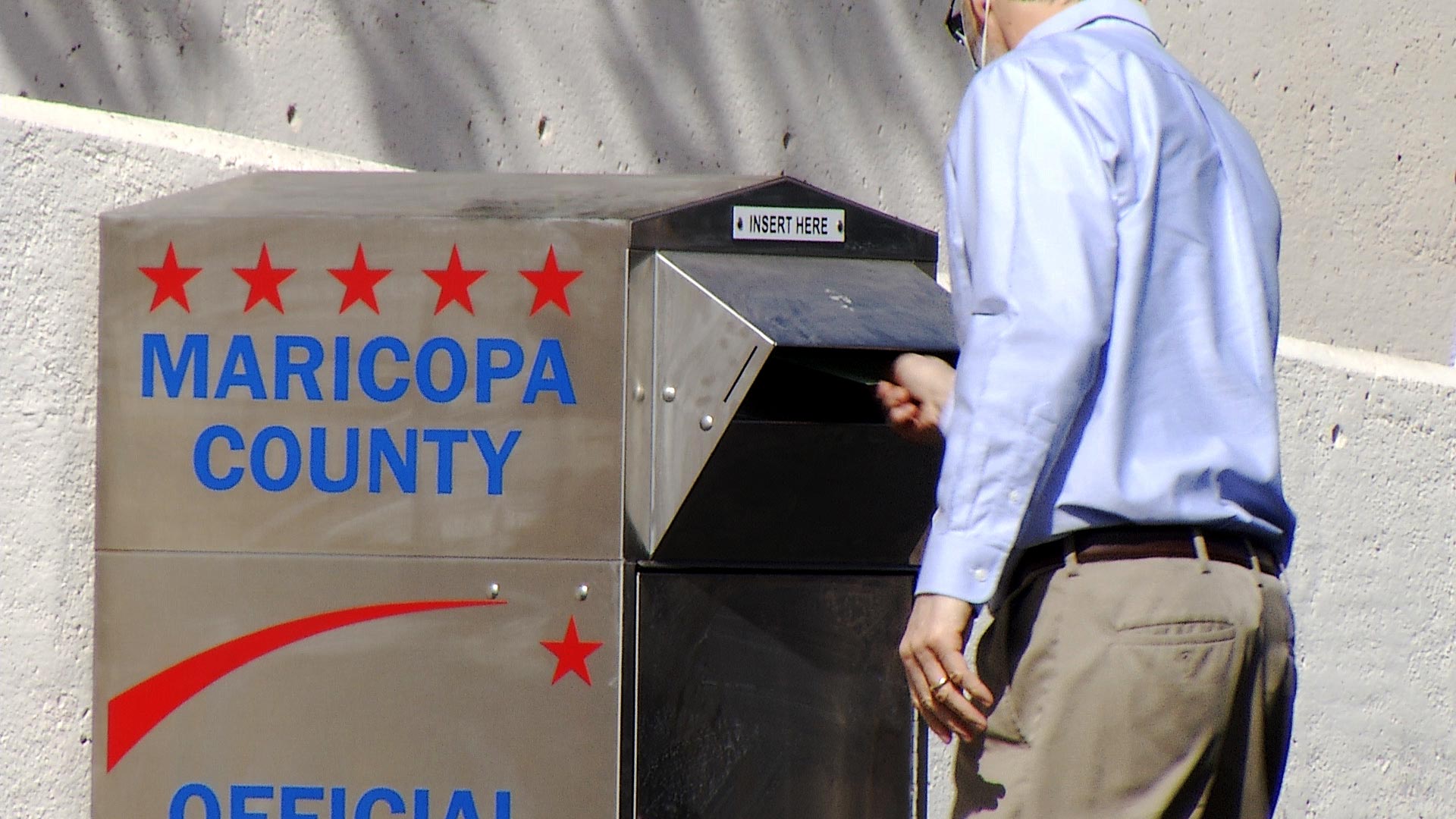 A Maricopa County voter turns in an early ballot on Oct. 26, 2020. 