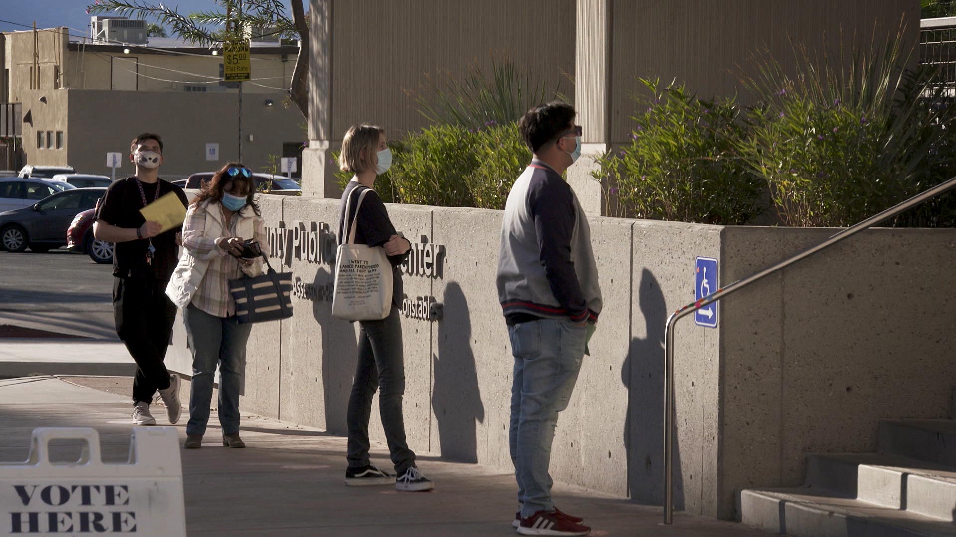 Voters wait to enter an early voting site at the Pima County Recorder's Office in downtown Tucson on Oct. 27, 2020. 