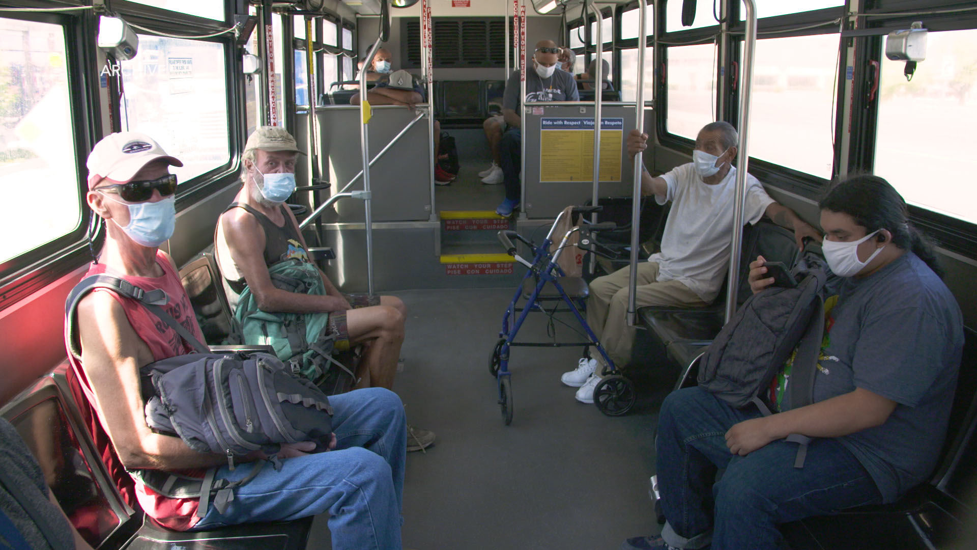 Community members travel by bus during the COVID-19 pandemic.