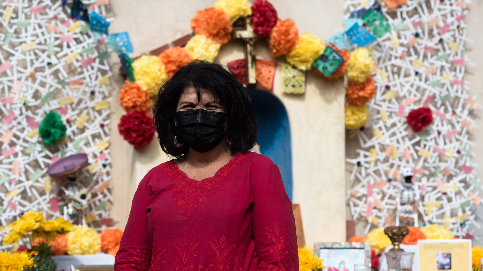 Betty Villegas stands in front of the Dia de los Muertos shrine at the Sosa Carillo house in barrio libre.