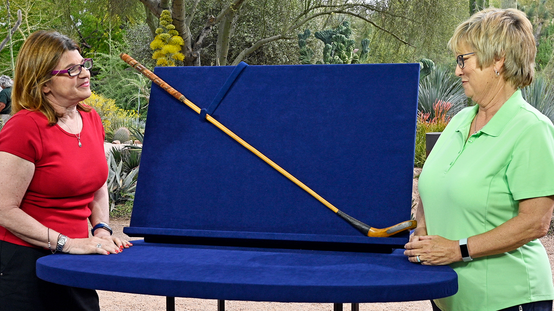 Leila Dunbar (left) appraises a Scottish golf club at Desert Botanical Garden in Phoenix. 