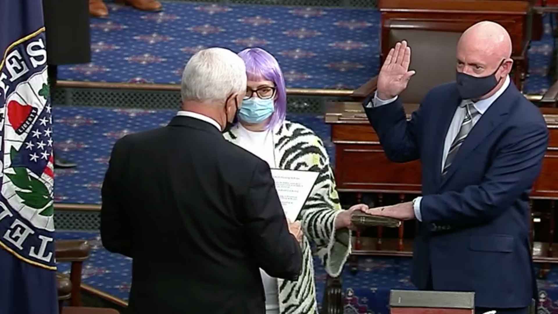 Sen. Mark Kelly is sworn into office by Vice President Mike Pence on Dec. 2, 2020.  Kelly was joined by Sen. Kyrsten Sinema.