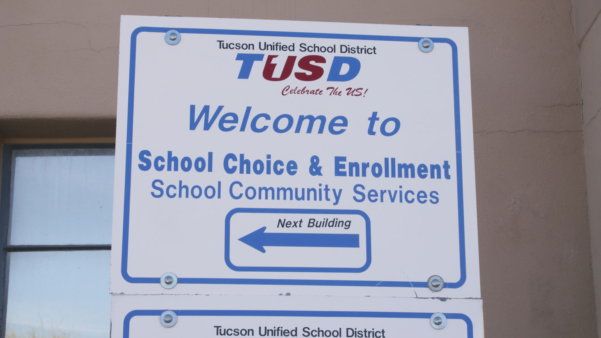 A welcome sign outside the Tucson Unified School District building.