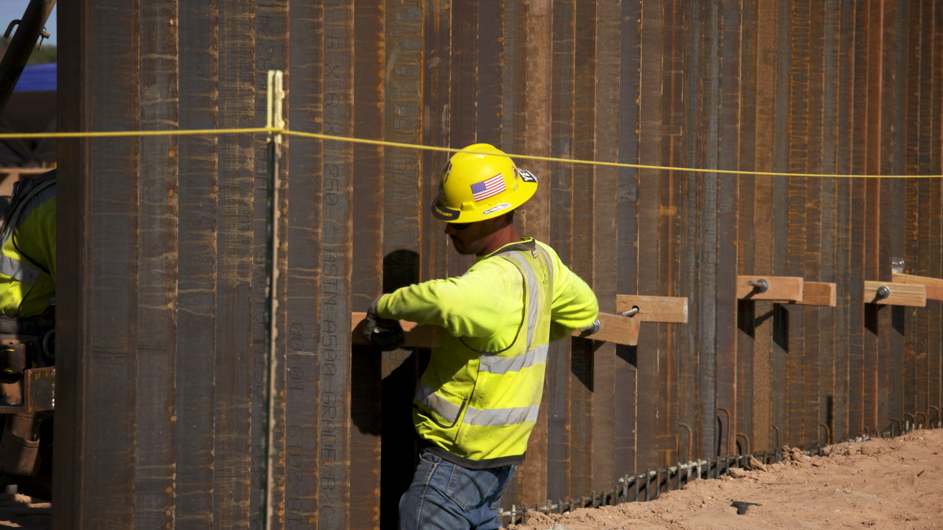 A construction worker works on installing 30-foot bollard fencing along Arizona's border with Mexico in Organ Pipe Cactus National Monument, February 2020.

