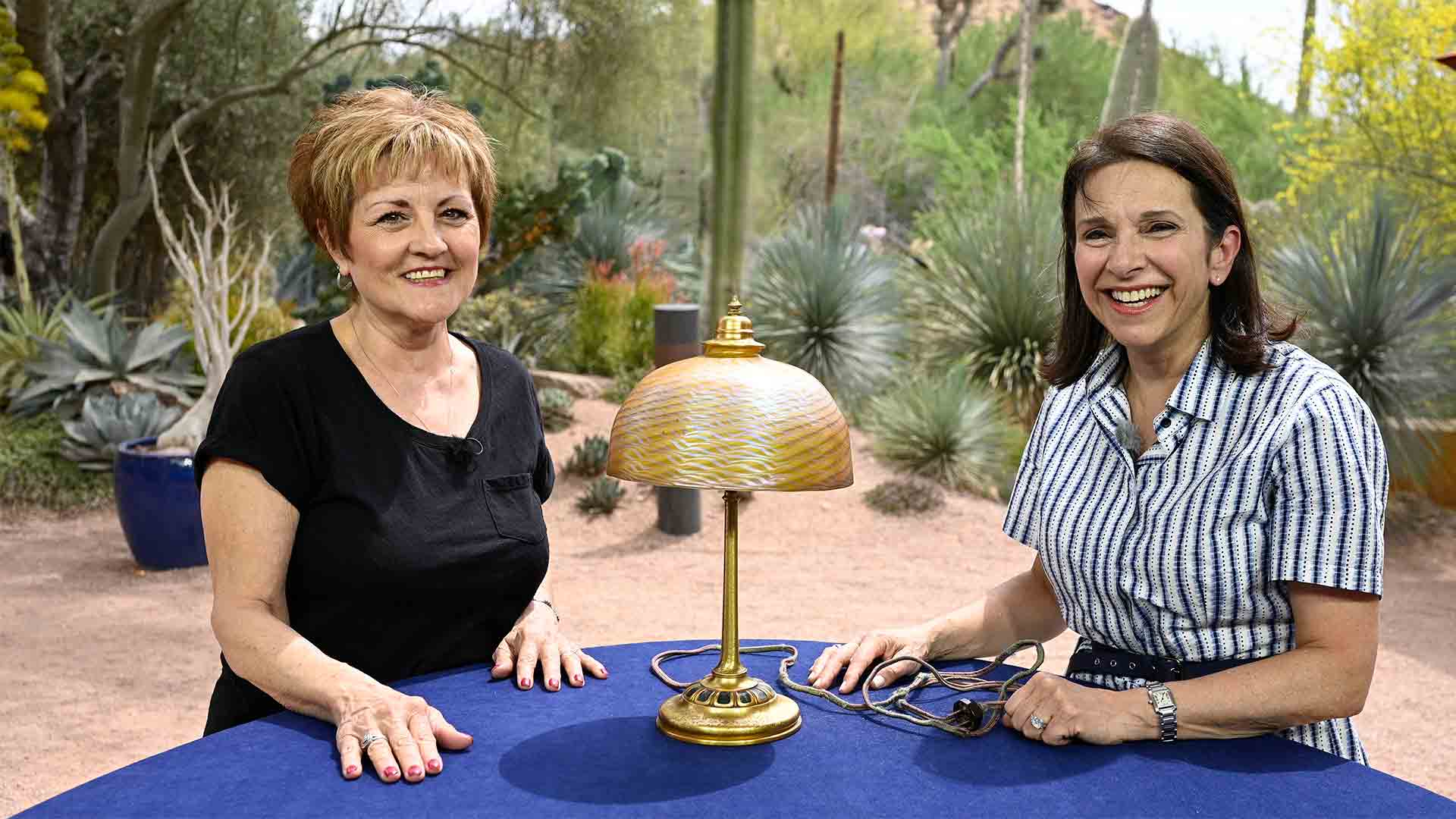 Arlie Sulka (right) appraises a Louis C. Tiffany Furnaces, Inc. table lamp, ca. 1925, at Desert Botanical Garden in Phoenix.