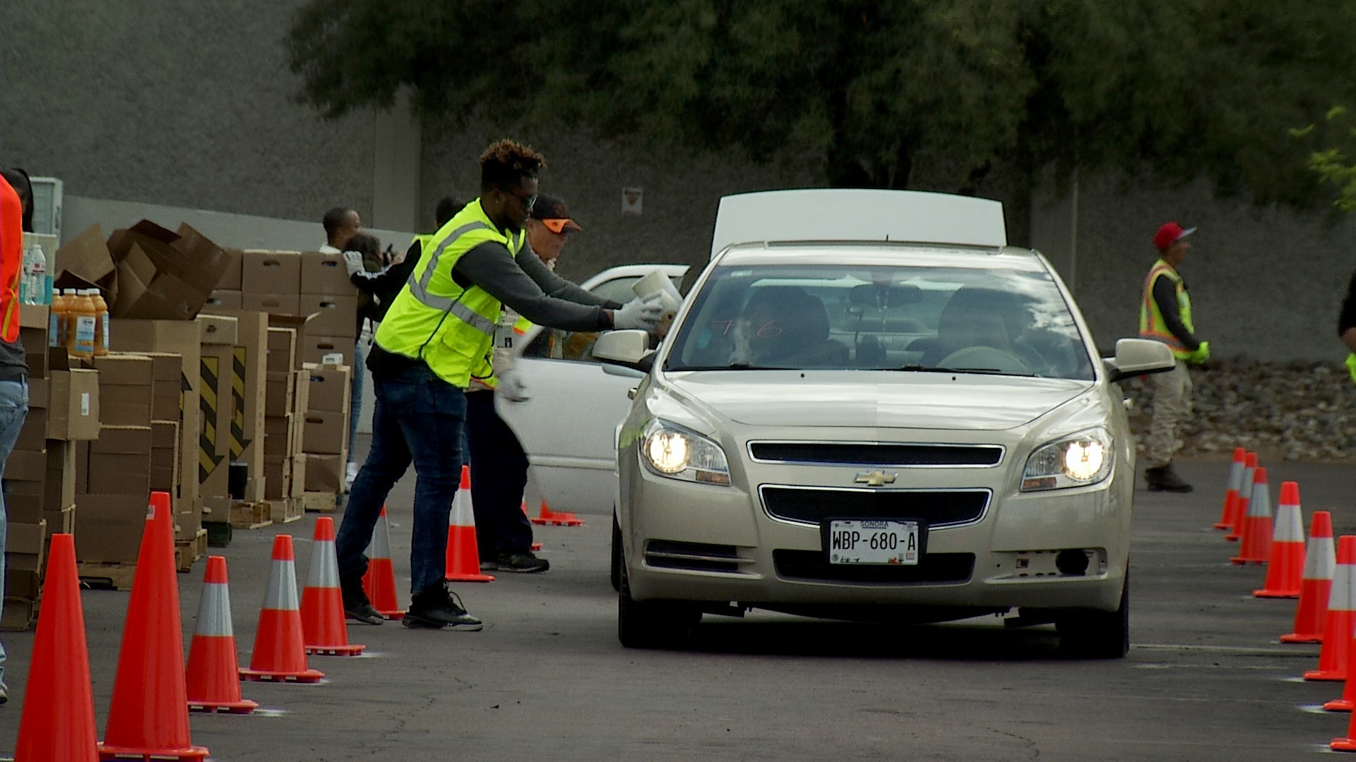 Volunteers with the Community Food Bank of Southern Arizona hand out goods in a drive-thru set up by the food bank in a move designed to limit person-to-person contact amid COVID-19 concerns. 