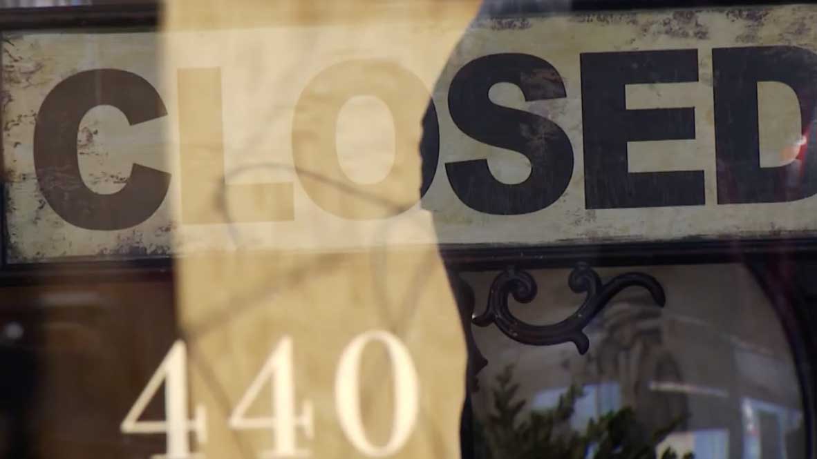 A business displays a closed sign on Fourth Avenue in Tucson amid the COVID-19 pandemic.