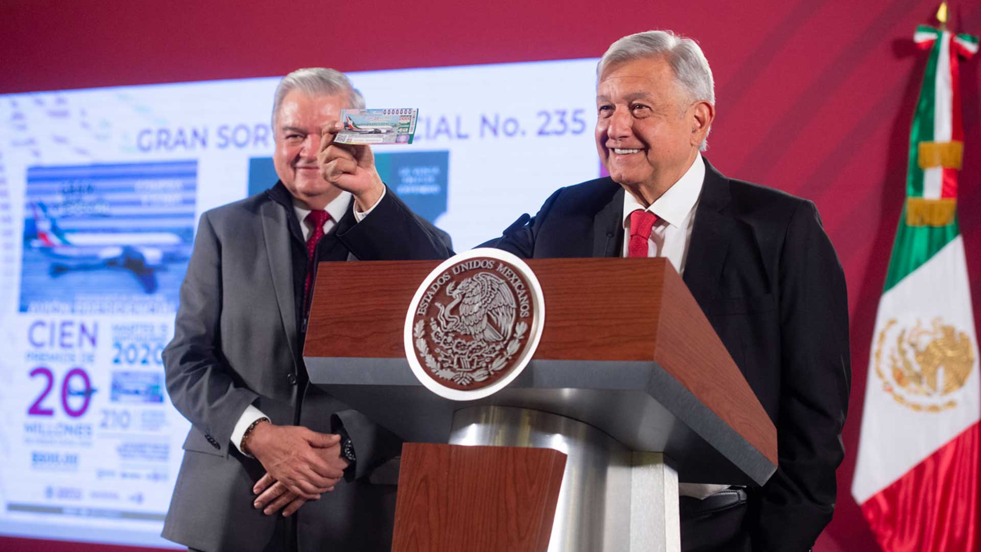 Mexican President Andrés Manuel López Obrador shows the ticket he purchased for the presidential airplane raffle.
