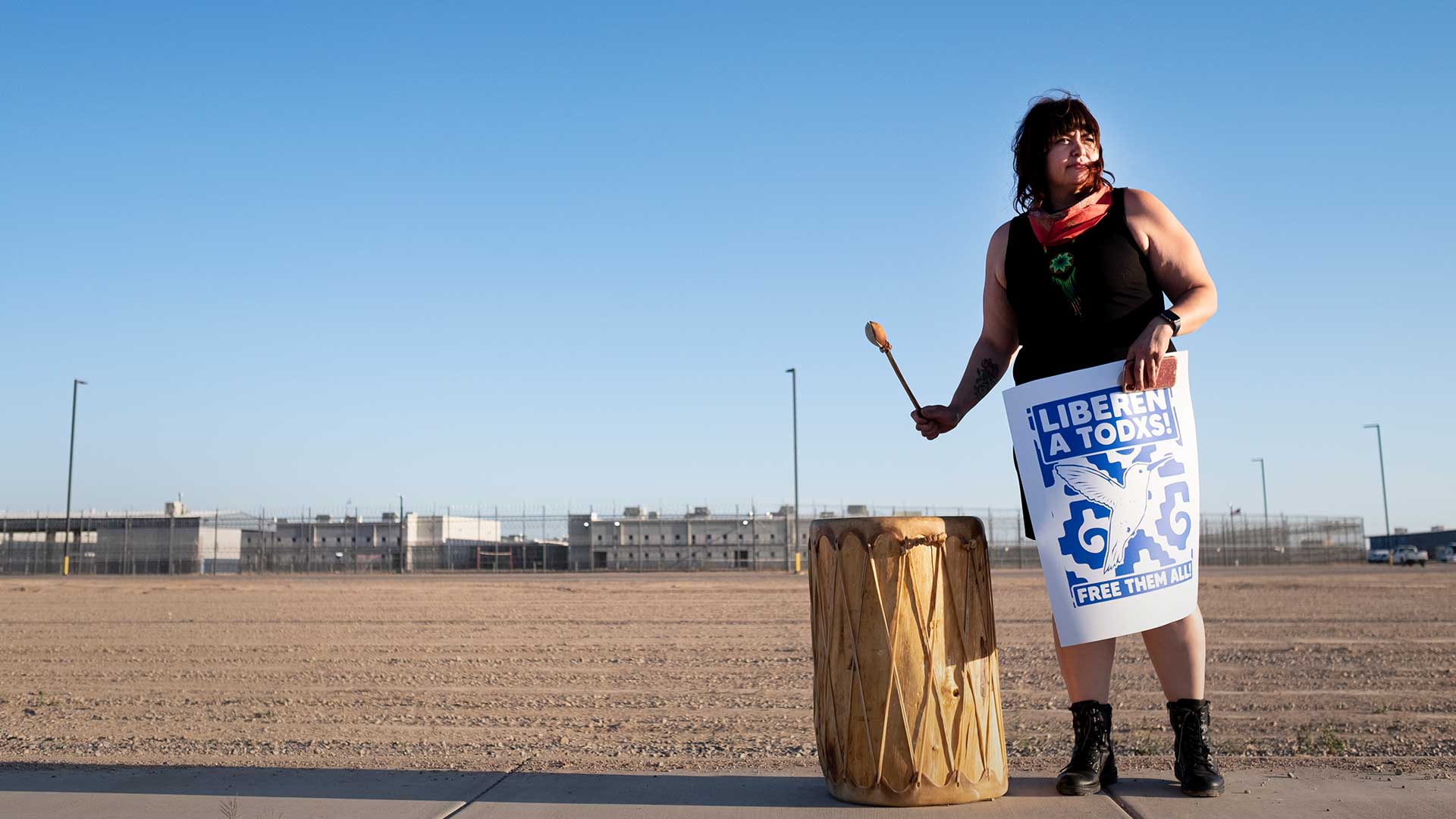 A protester bangs a drum on the sidewalk outside the La Palma Detention Center in Eloy, Arizona. Protesters in over 200 cars circled the facility on on April 10 calling for the release of detainees in the wake of the coronavirus pandemic.
