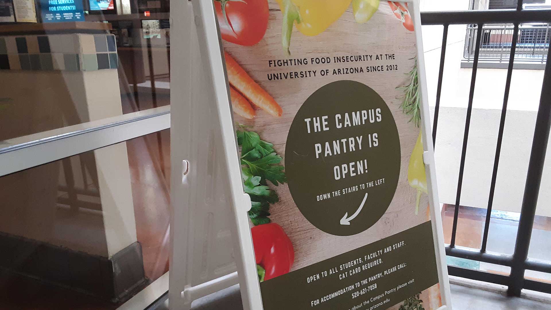 A sign points to the new UA Campus Pantry location at the Student Union Memorial Center