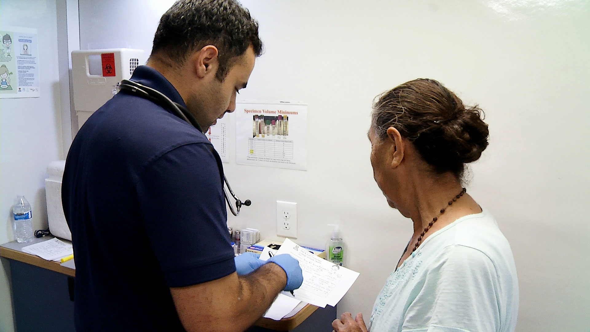 A community health worker with the University of Arizona talks to a client during a mobile health screening event in Arizona in this photo taken prior to the COVID-19 pandemic.