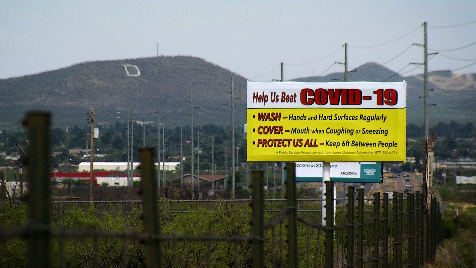 A sign urging protective measures against the novel coronavirus along a road in Douglas, Arizona. April 2020.