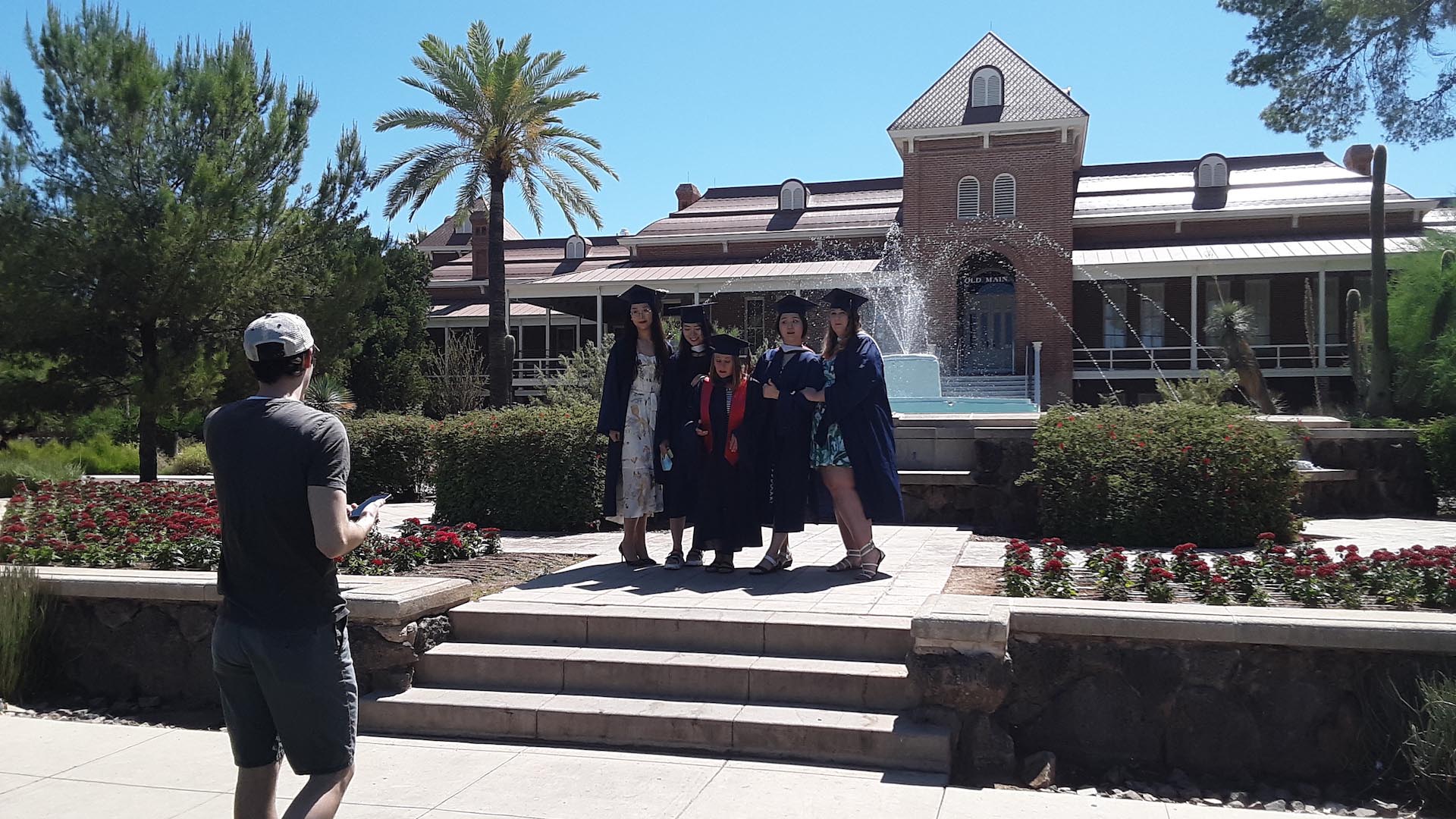 Spring 2020 University of Arizona graduates pose for photos at Old Main.