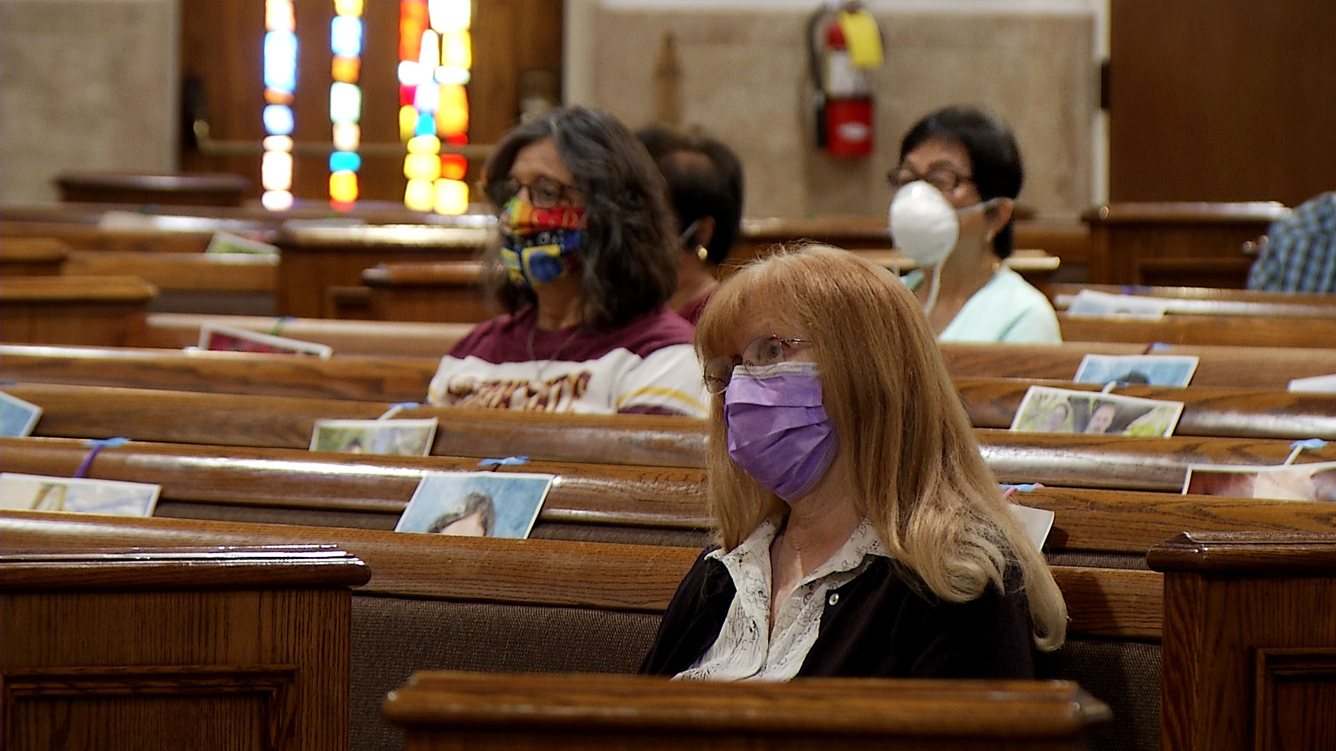 Parishioners attend mass at St. Mary's Church in Chandler on May 19, 2020. The Catholic Diocese of Phoenix gave pastors the option to resume public mass with limited capacity and face masks as added safety precautions. Photos of the congregation's members fastened to the pews indicate spaces where people cannot sit. 