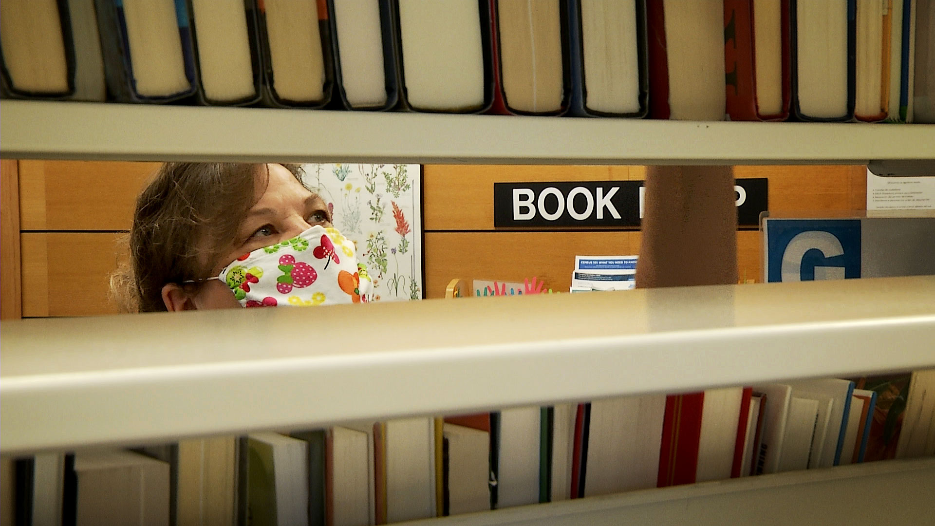 Pima County Public Library director Amber Mathewson organizes books at the system's downtown branch on May 29, 2020. 