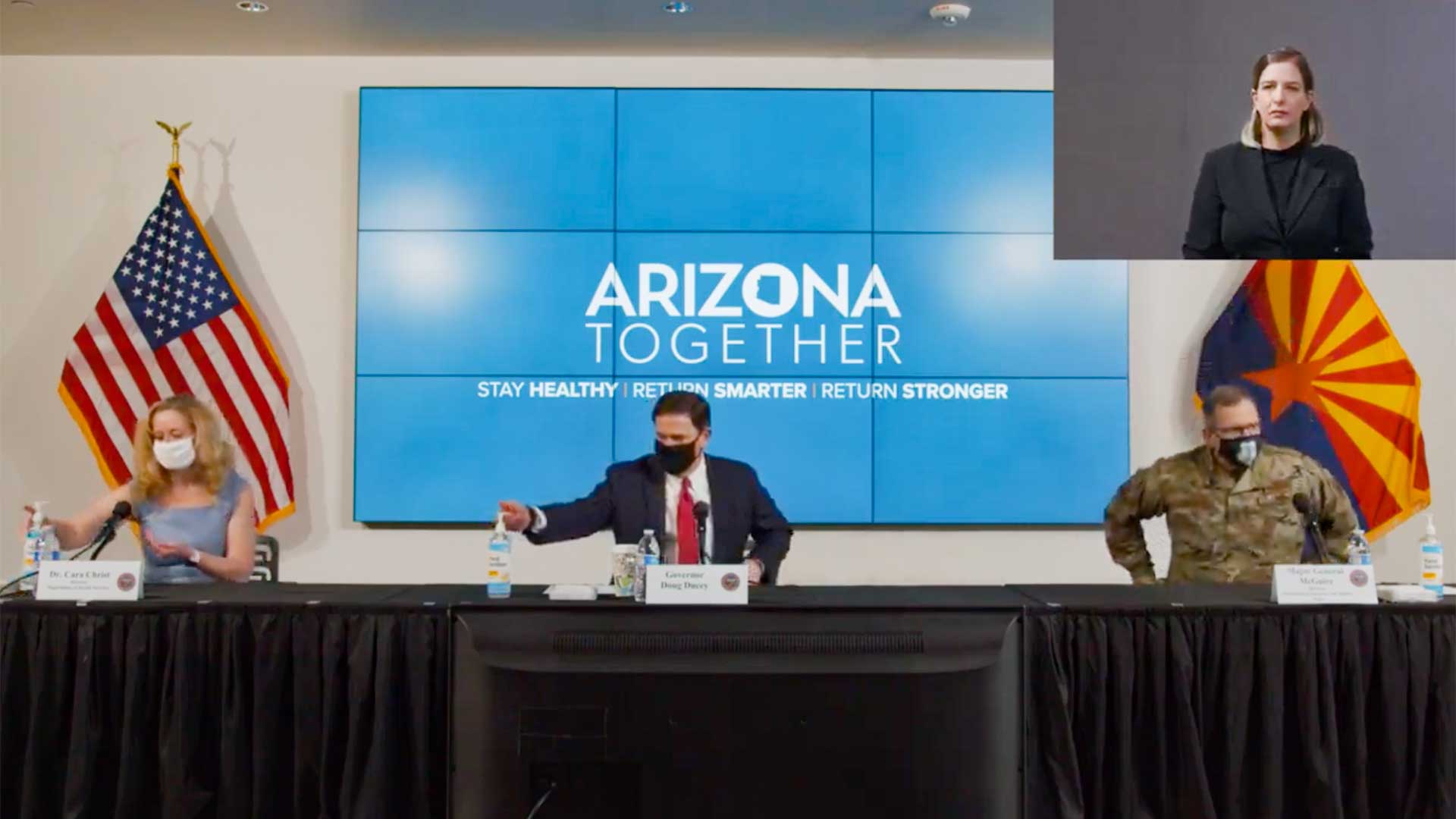 ADHS Director Cara Christ, Gov. Doug Ducey and Maj. Gen. Michael McGuire show up to a June 17 meeting wearing masks. They removed the masks after sitting down.