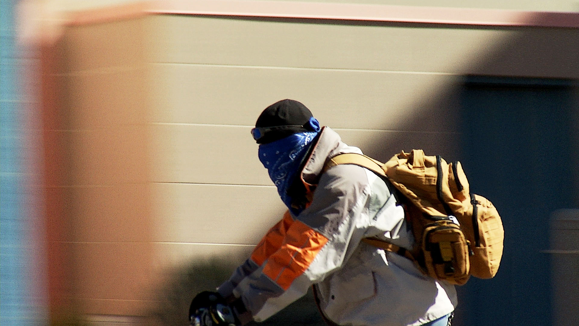 A cyclist wears a bandana over his face as he bikes in Nogales, March 2020. 
