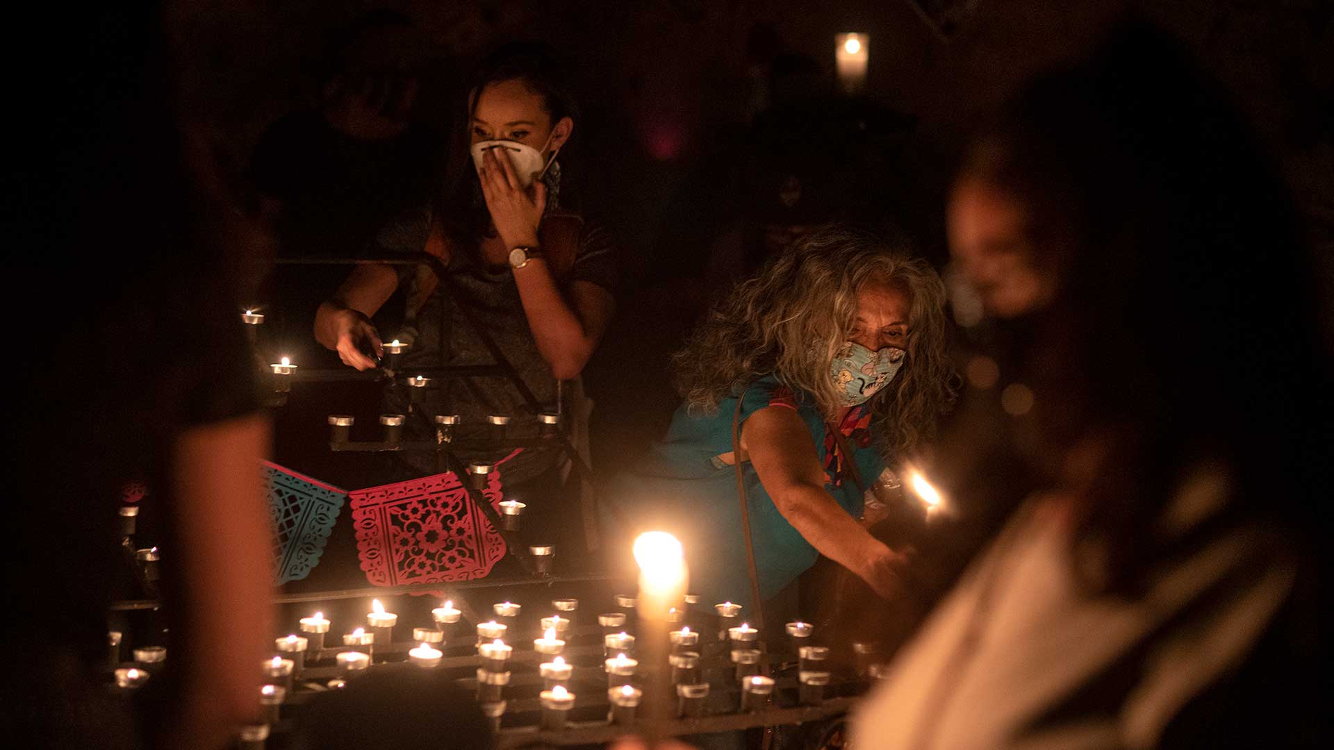 Community members and family of Carlos Adrian Ingram-Lopez light candles in his memory at the El Tiradito shrine on June 25, 2020.